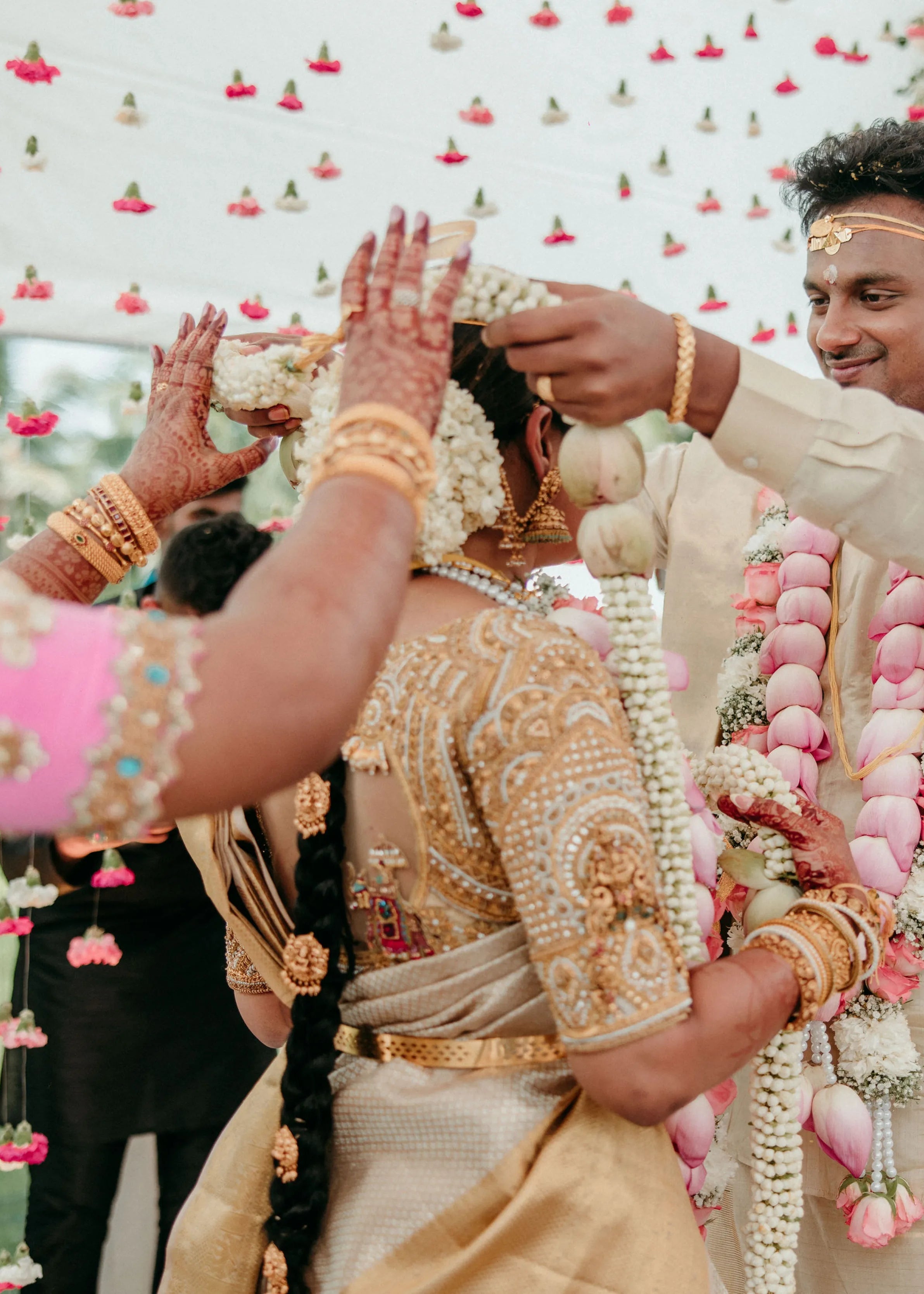Bride Divya posing in a gold silk blouse handcrafted by team Archana Karthick.