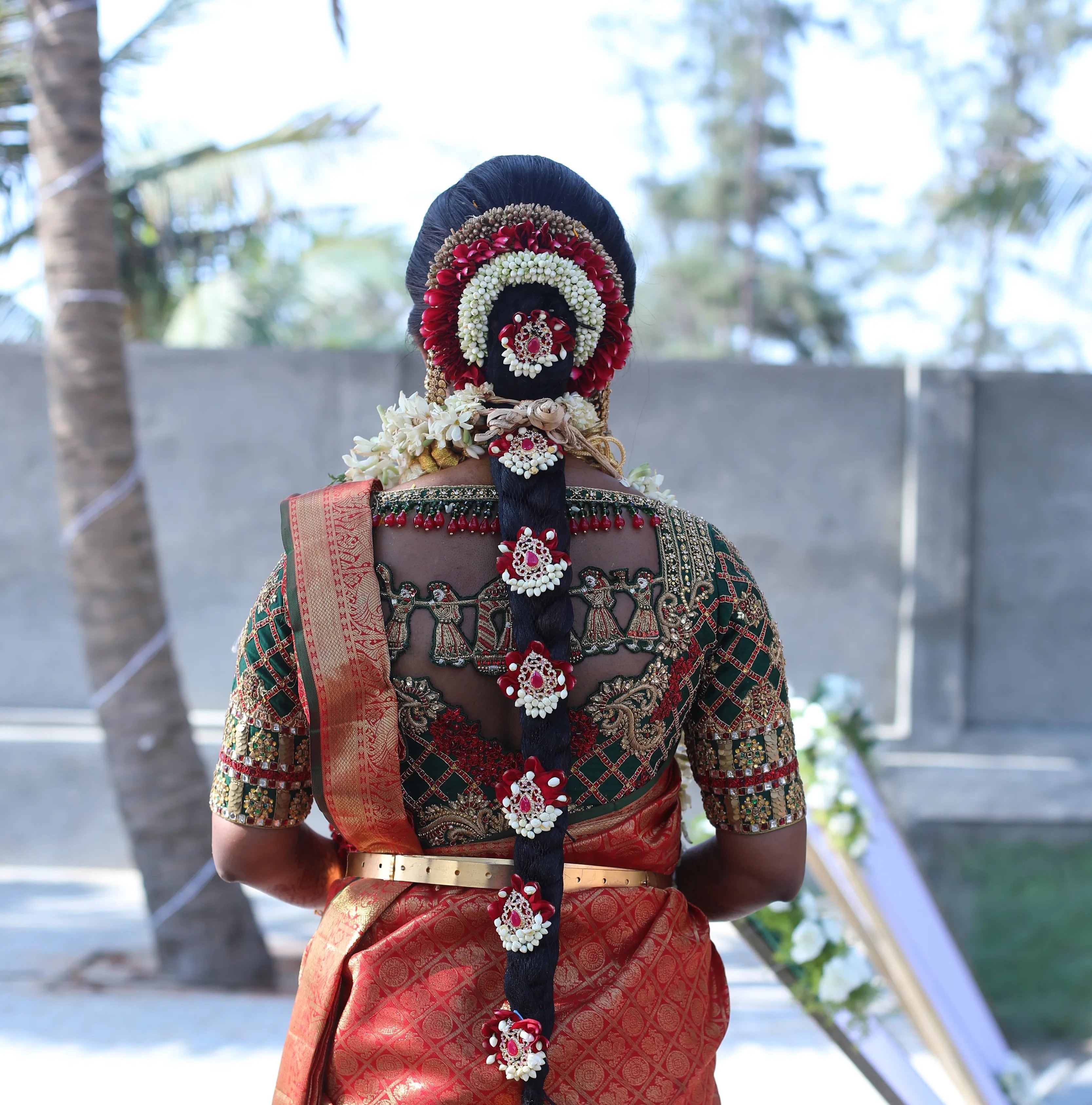 Bride Gayathri in a palanquin concept bottle green silk blouse, handcrafted with kemp stones, zardozi, coins and crystals by team Archana Karthick.