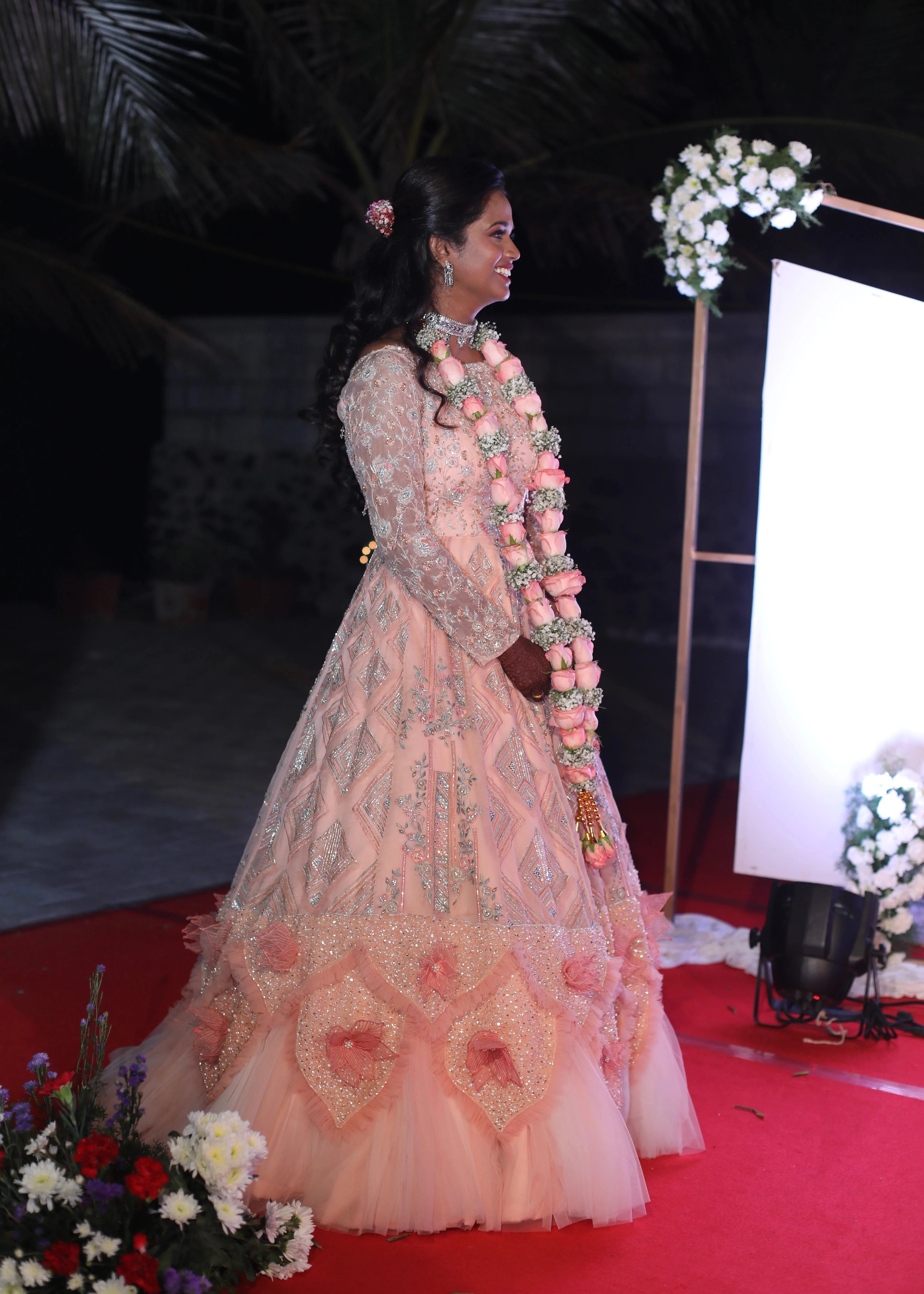 Bride Gayathri in a peach cream tulle gown, handcrafted with applique work, stones, sequins, zari, cutdana and resham by team Archana Karthick.