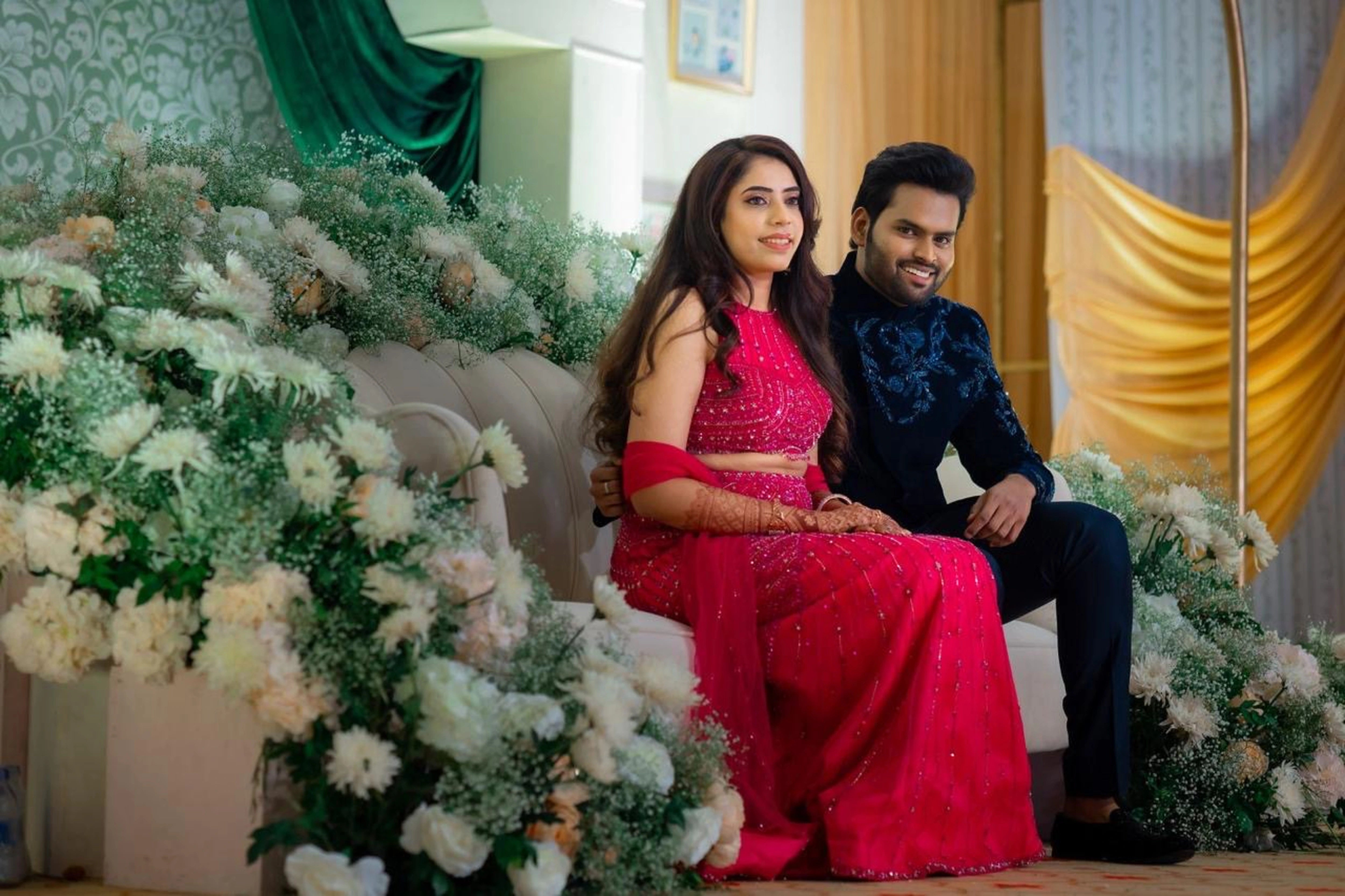 Bride & Groom in a pink tulle mermaid lehenga and midnight blue velvet bandhgala, intricately handcrafted by team Archana Karthick