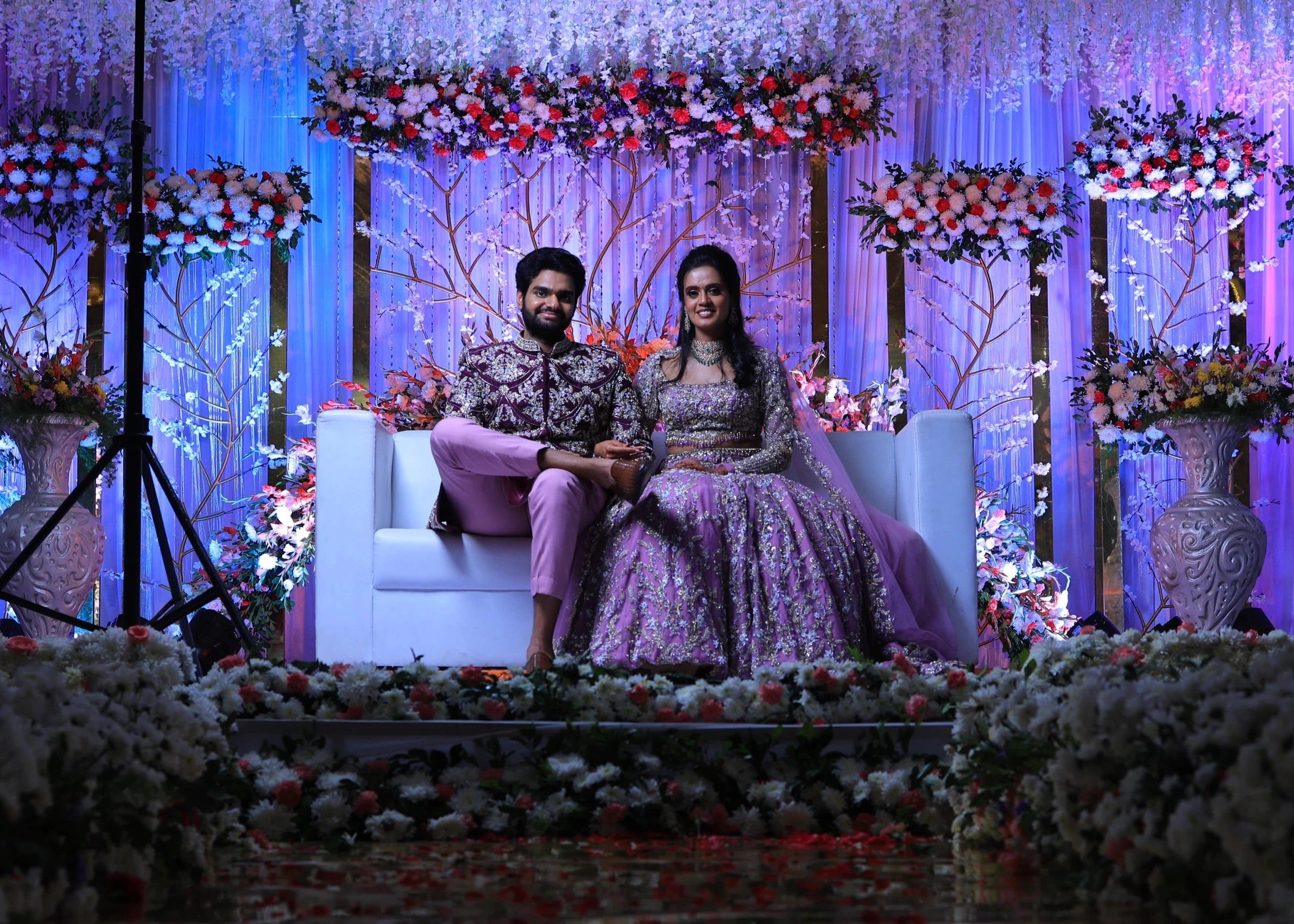 Bride & Groom on stage in lavender raw silk lehenga and sherwani, handcrafted with sequins, cutdana, beads, crystals, rhinestones and zardozi by Archana Karthick