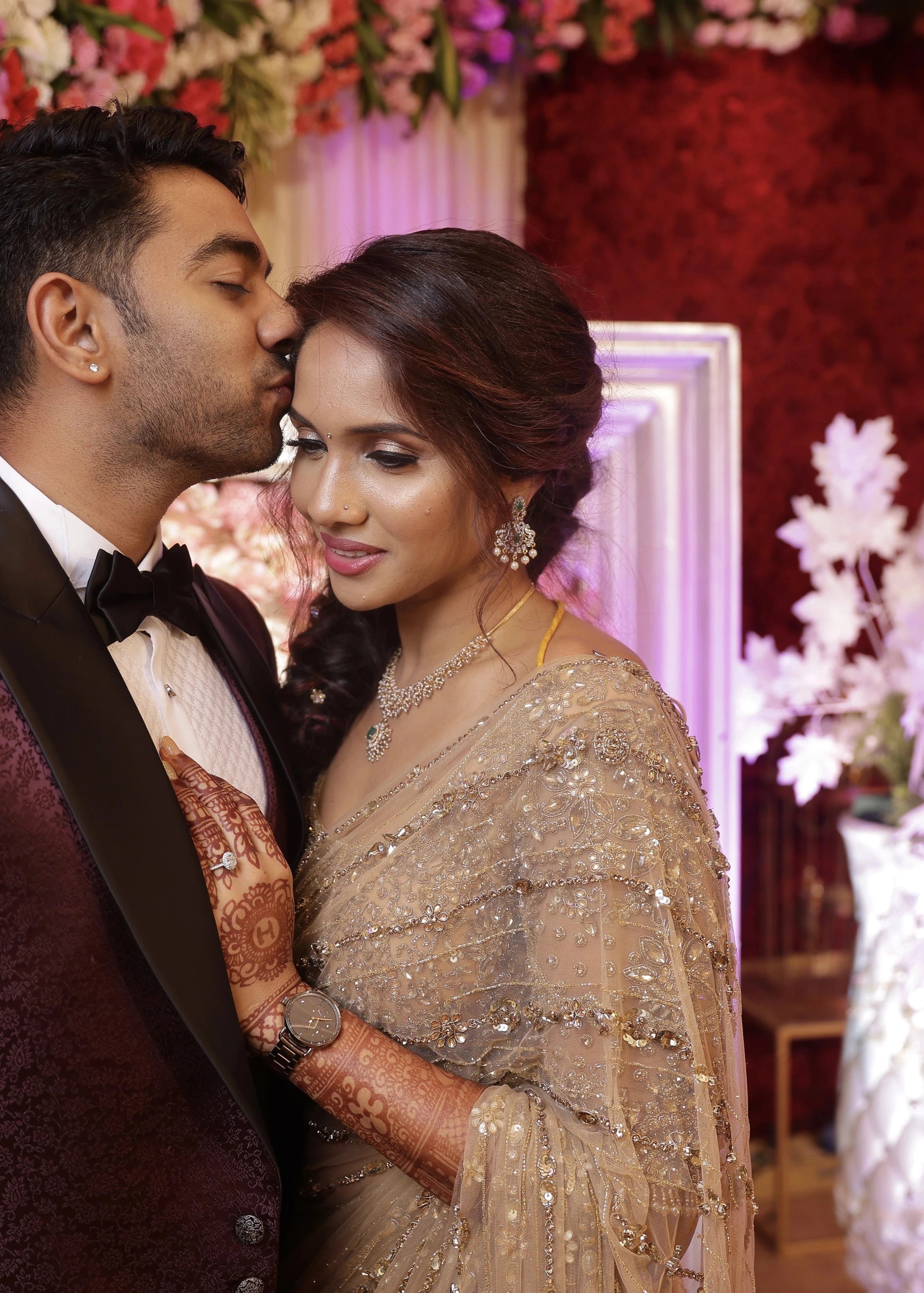 Bride Harine from San francisco embracing the groom in a gold tulle saree, handcrafted with rhinestones, zardozi, sequins, crystals, cutdana and stones by team Archana Karthick.