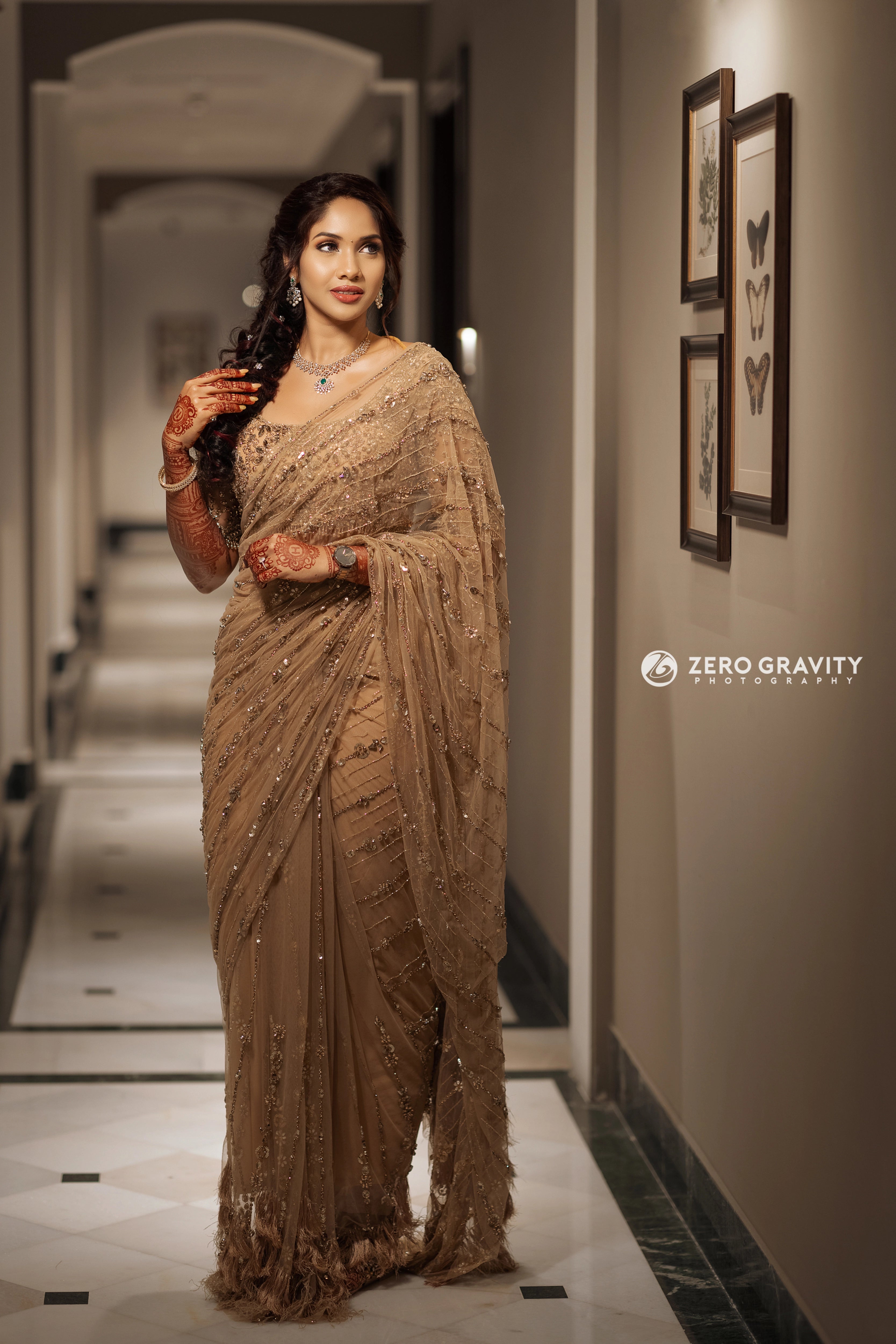 Bride Harine from San francisco in a gold tulle saree, handcrafted with rhinestones, zardozi, sequins, crystals, cutdana and stones by team Archana Karthick.