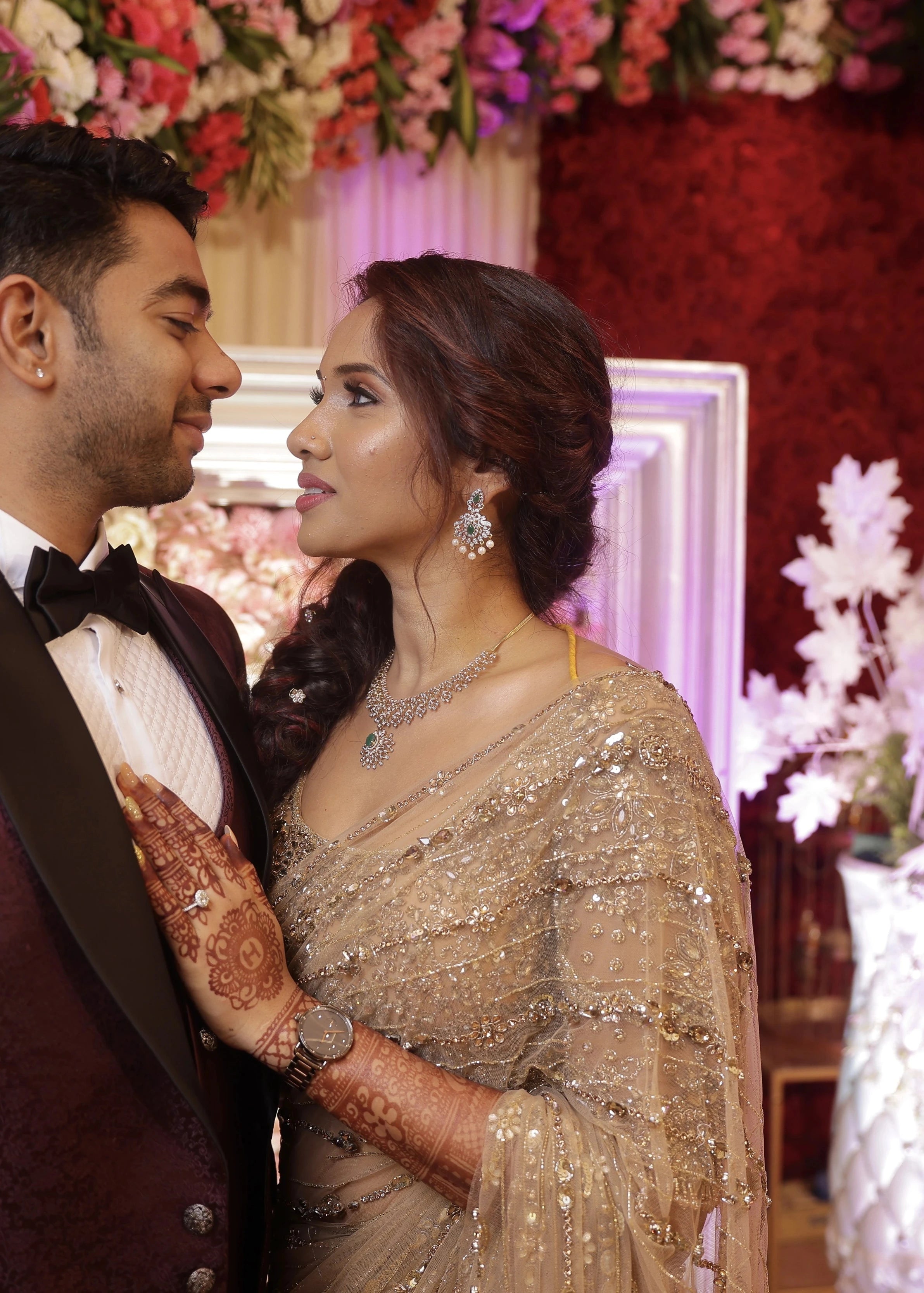 Bride Harine from San francisco in an embrace with groom in a gold tulle saree, handcrafted with rhinestones, zardozi, sequins, crystals, cutdana and stones by team Archana Karthick.