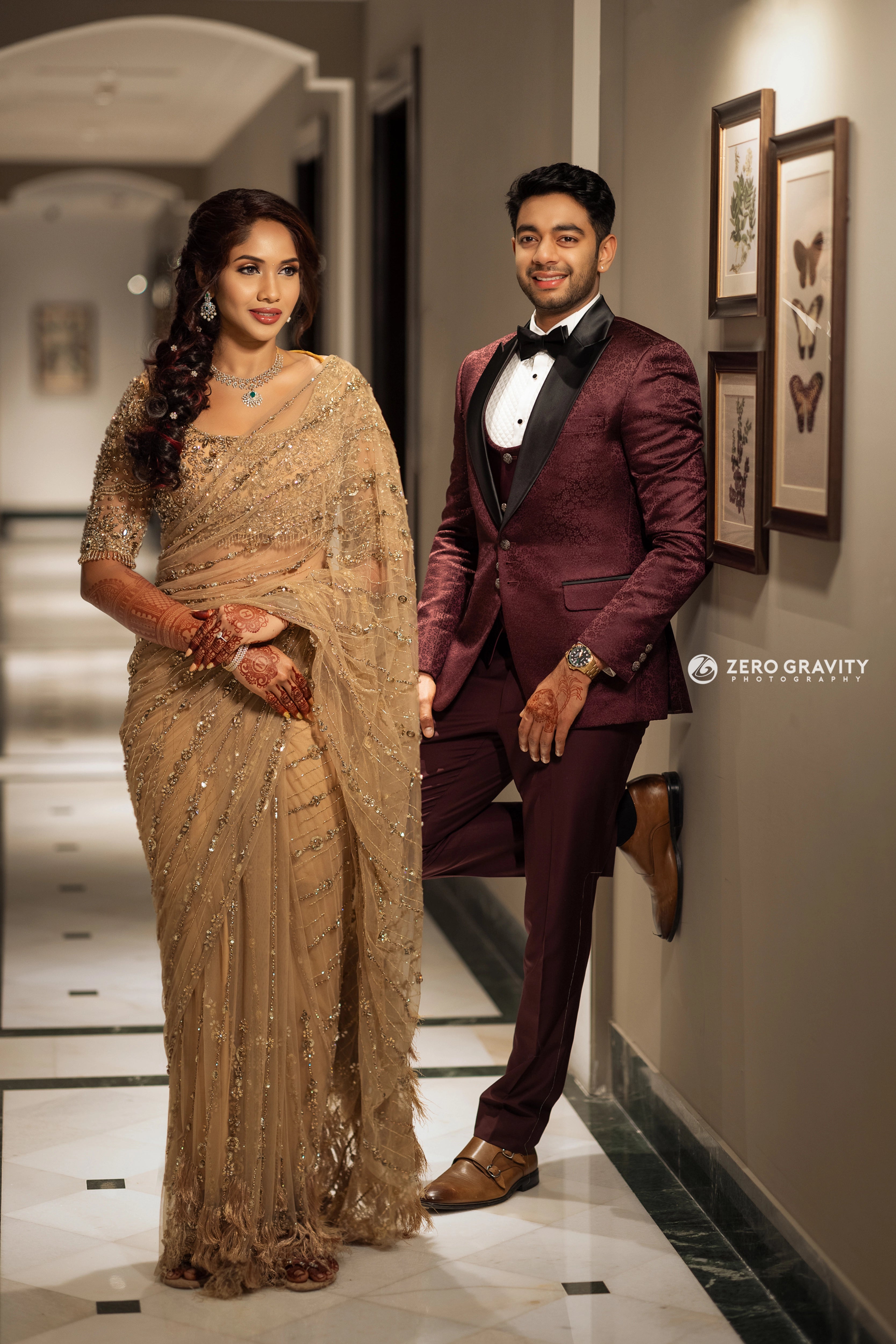 Bride Harine from San francisco posing with groom in a gold tulle saree, handcrafted with rhinestones, zardozi, sequins, crystals, cutdana and stones by team Archana Karthick.