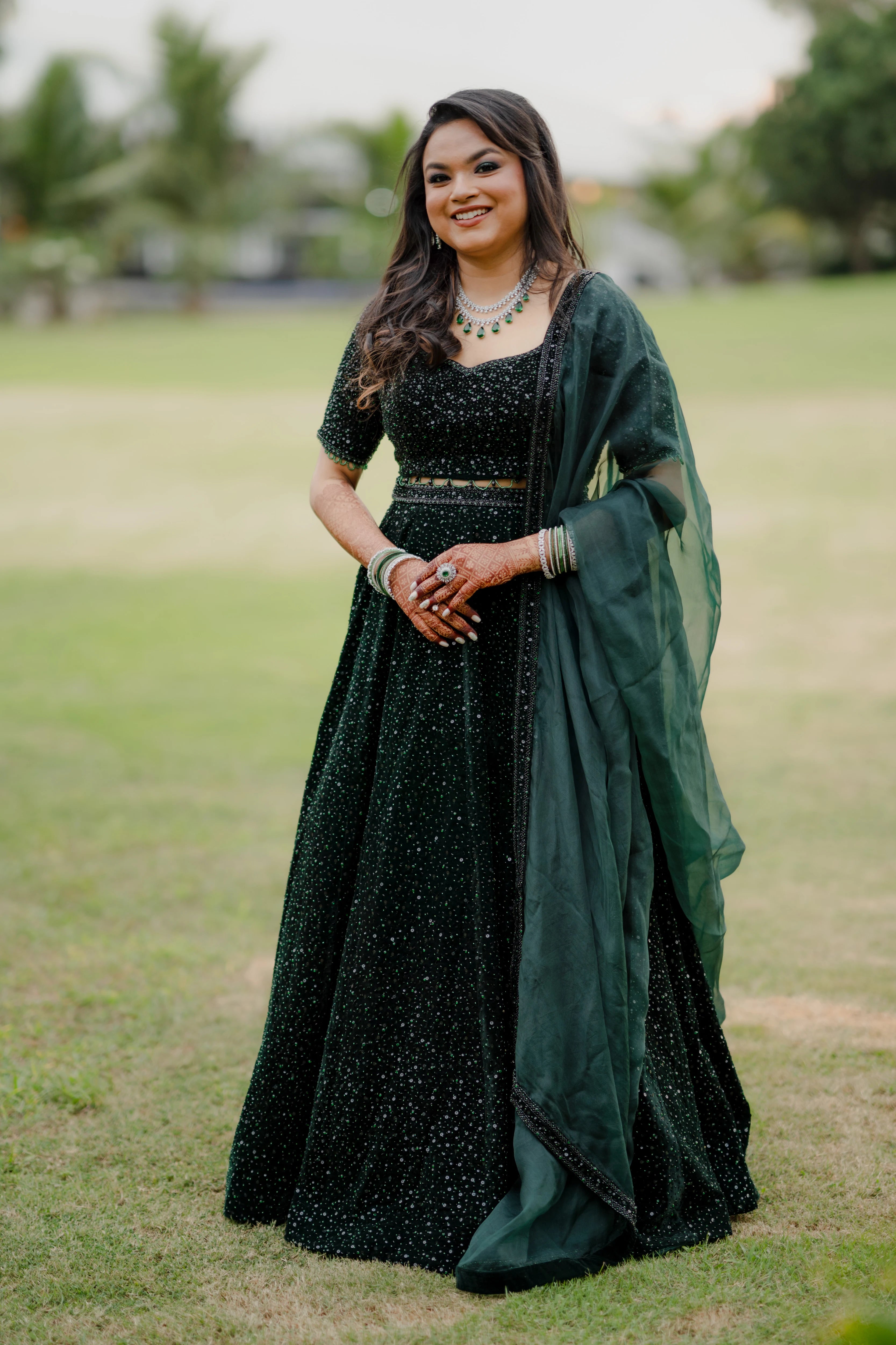 Bride Haripriya from USA in a bottle green velvet lehenga, intricately handcrafted with sequins, cutdana, beads and crystals by team Archana Karthick.
