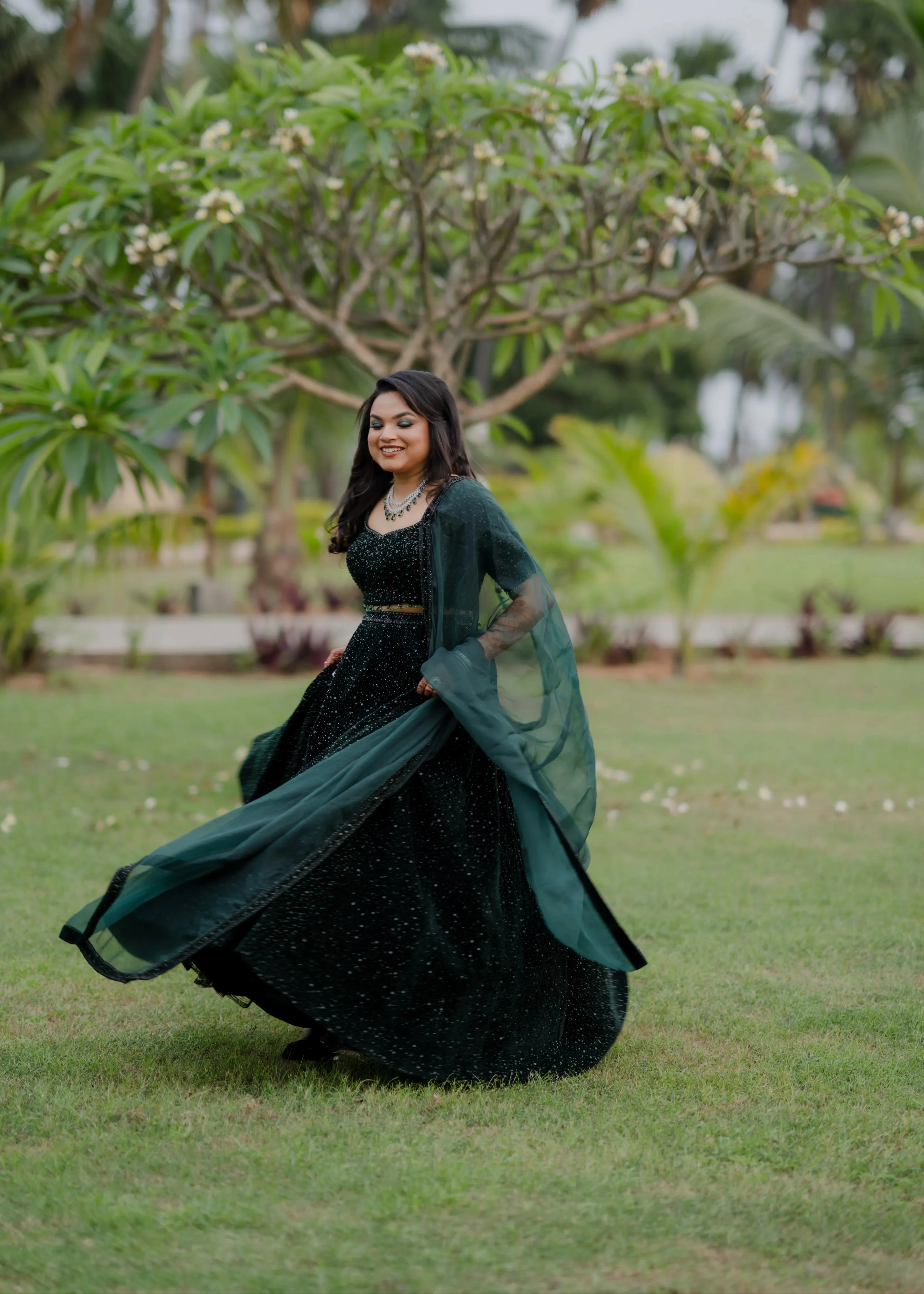 Bride Haripriya from USA twirling in a bottle green velvet lehenga, intricately handcrafted with sequins, cutdana, beads and crystals by team Archana Karthick.