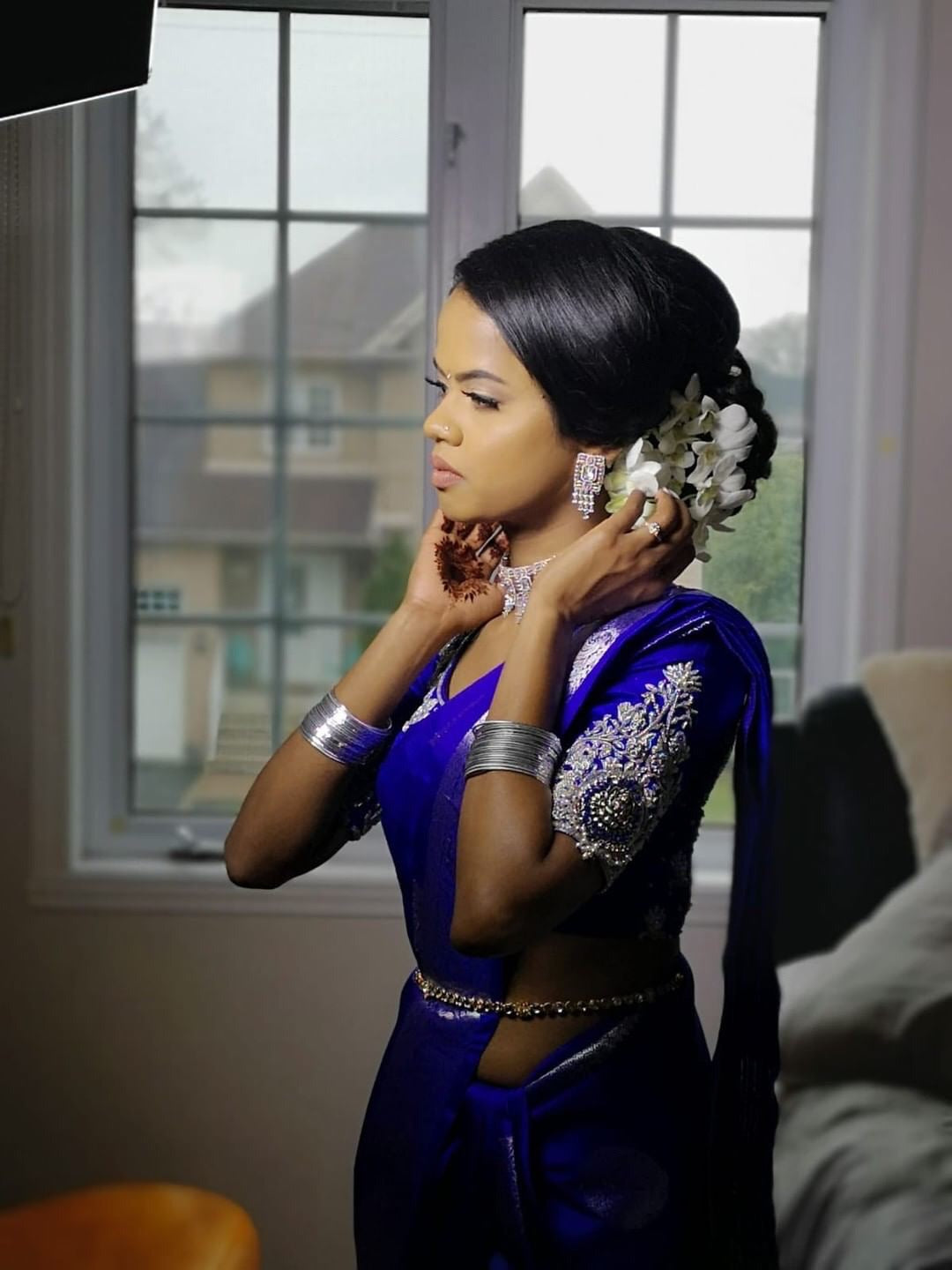 Bride Hemini from Canada in a blue silk blouse handcrafted intricately with beads, pearls, resham and zardozi.
