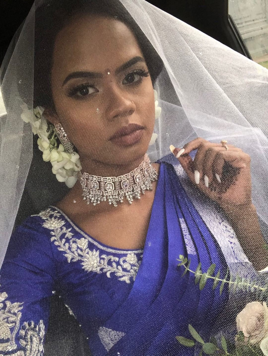 Bride Hemini from Canada posing in a blue silk blouse handcrafted intricately with beads, pearls, resham and zardozi.
