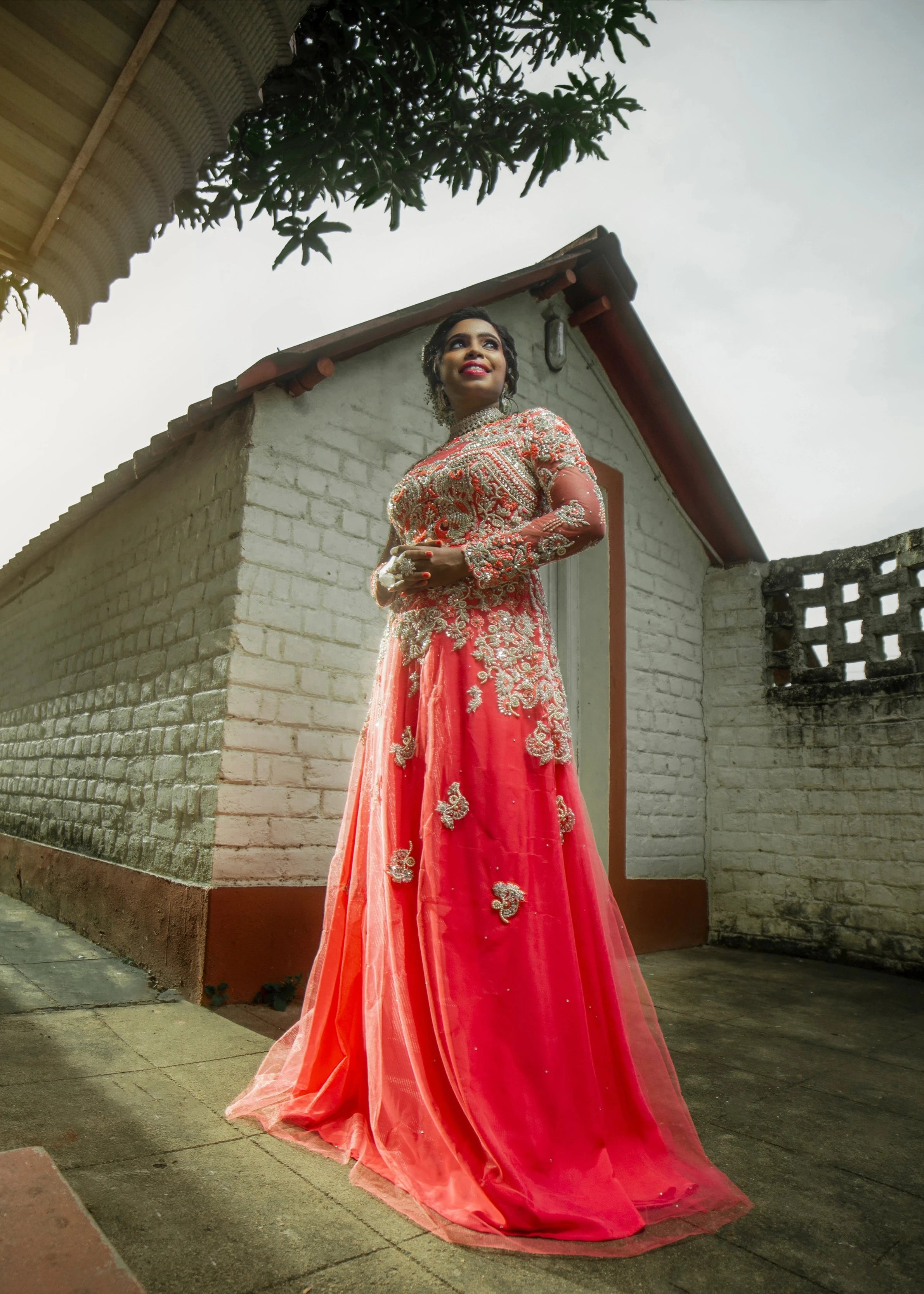 Bride Jayanthi posing in a hot pink tulle gown, intricately handcrafted with beads, pearls, cutdana, stones, resham and zardozi by team Archana Karthick.
