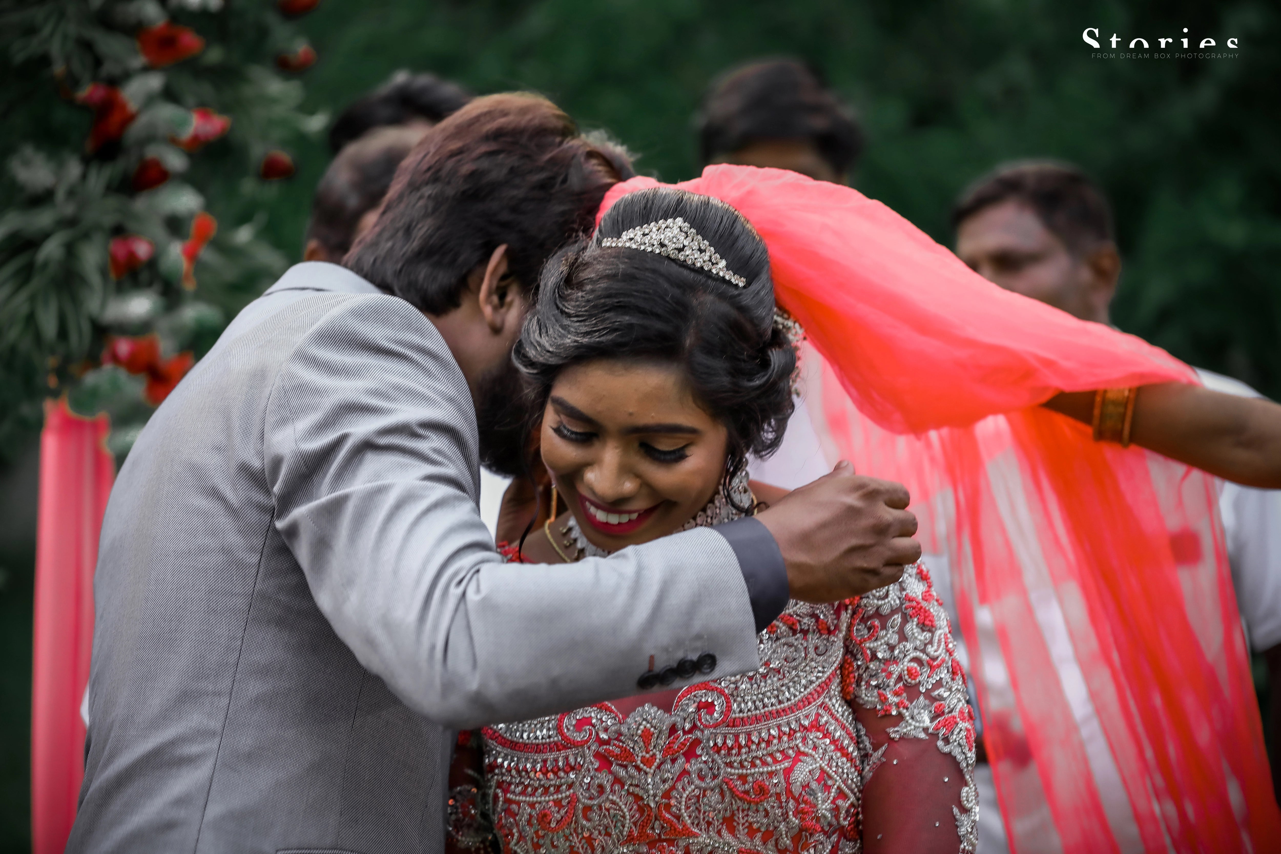 Bride Jayanthi posing with groom in a hot pink tulle gown, intricately handcrafted with beads, pearls, cutdana, stones, resham and zardozi by team Archana Karthick.