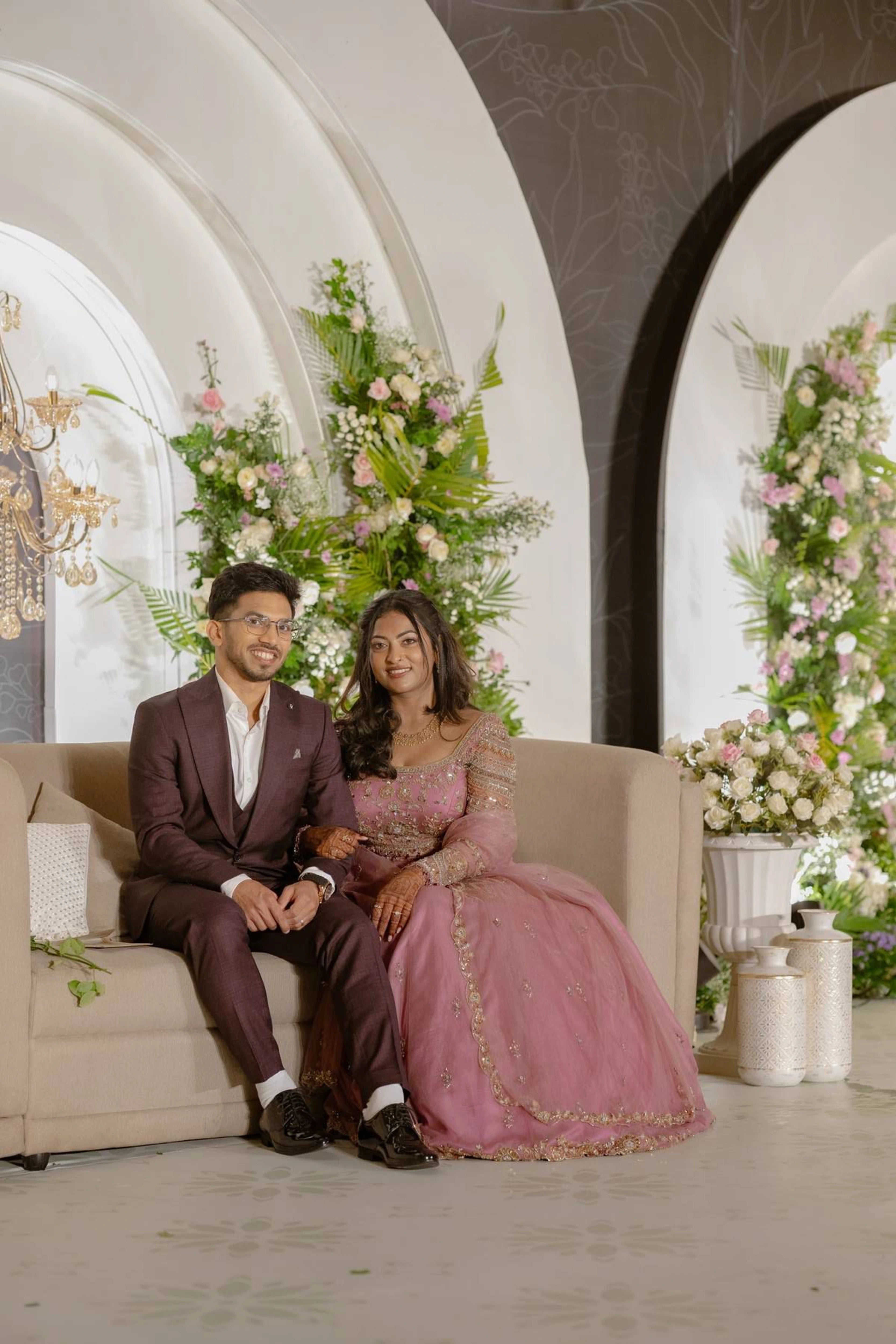 Bride Karoline from Qatar posing with groom in a lilac tulle lehenga by team Archana Karthick.