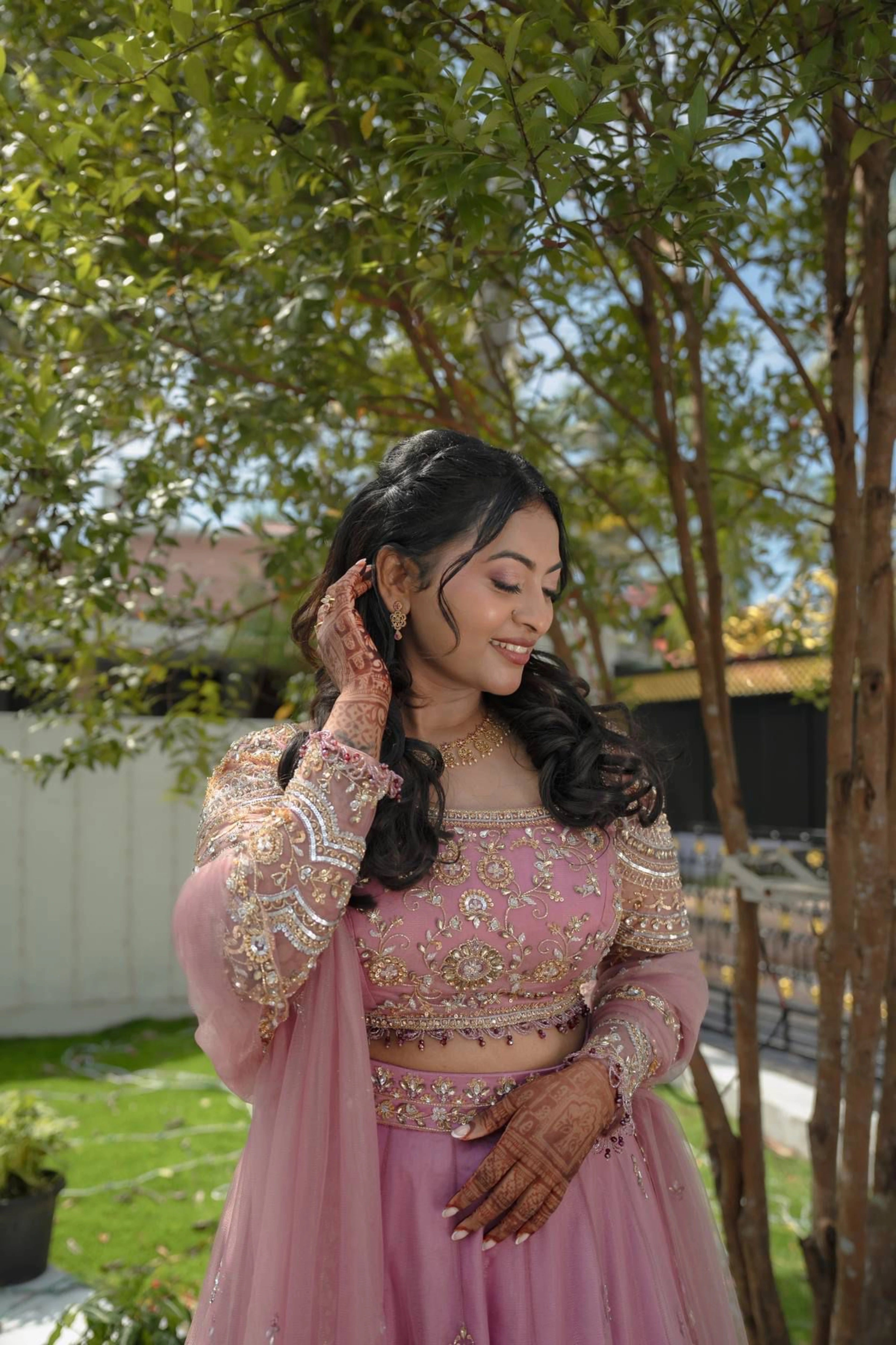 Bride Karoline from Qatar smiling in a lilac tulle lehenga by team Archana Karthick.