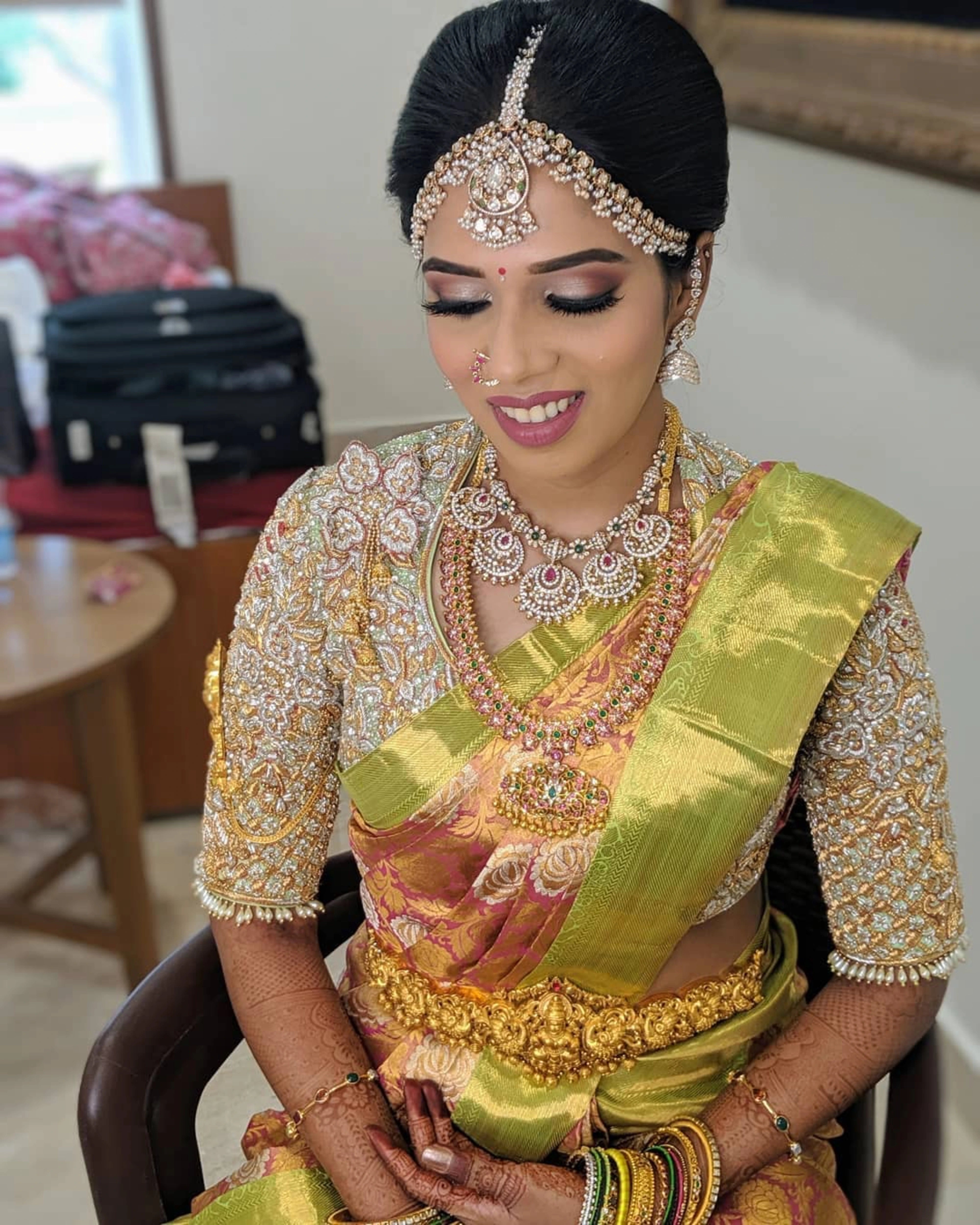 Bride Karthikeyani in a pistachio green silk palanquin concept blouse for her wedding, handcrafted with zardozi, pearls, stones, etc by team Archana Karthick.