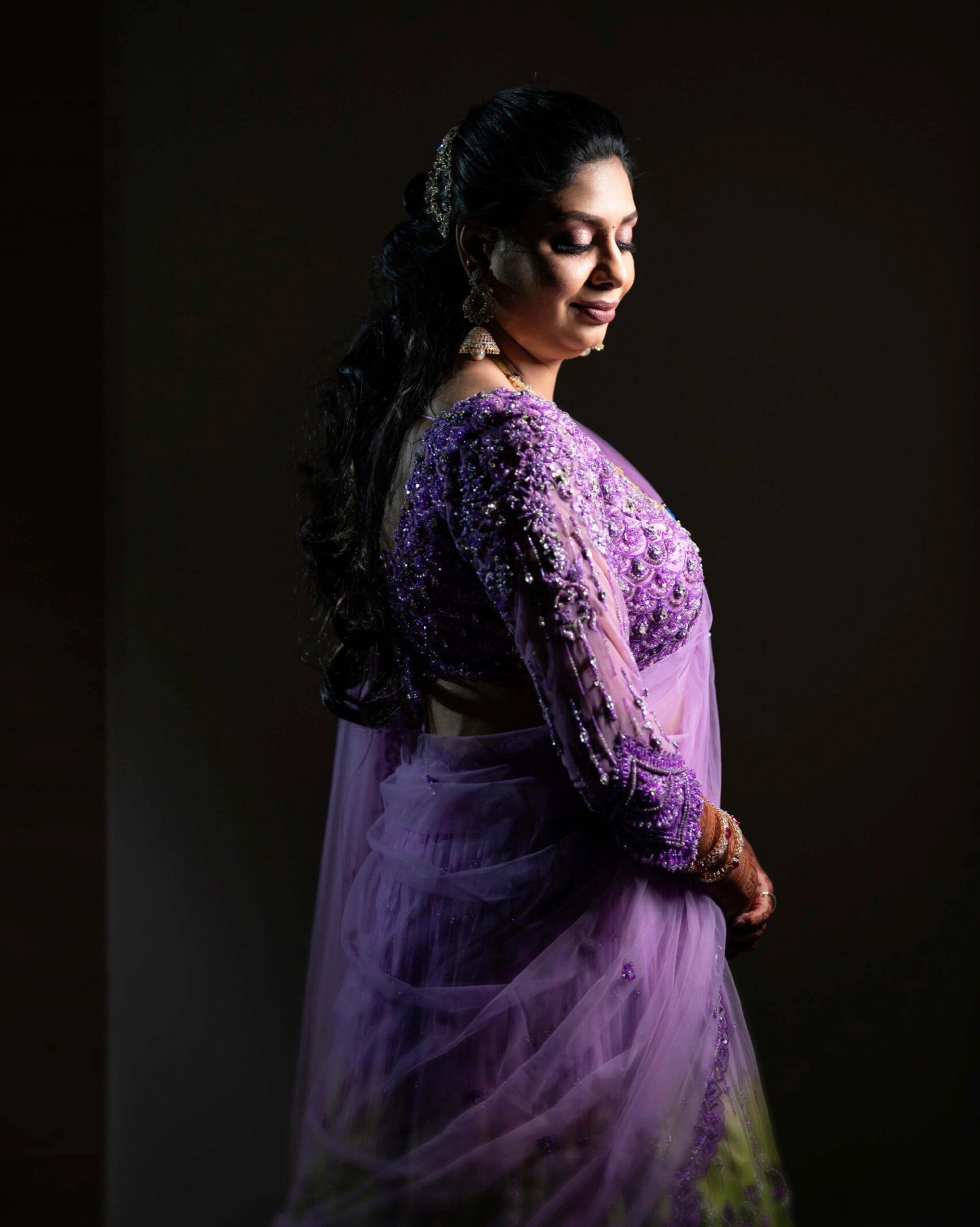 Bride Keerti posing for photoshoot in a lavender & green tulle lehenga, intricately handcrafted with sequins, cutdana, beads, crystals, rhinestones & zardozi by team Archana Karthick