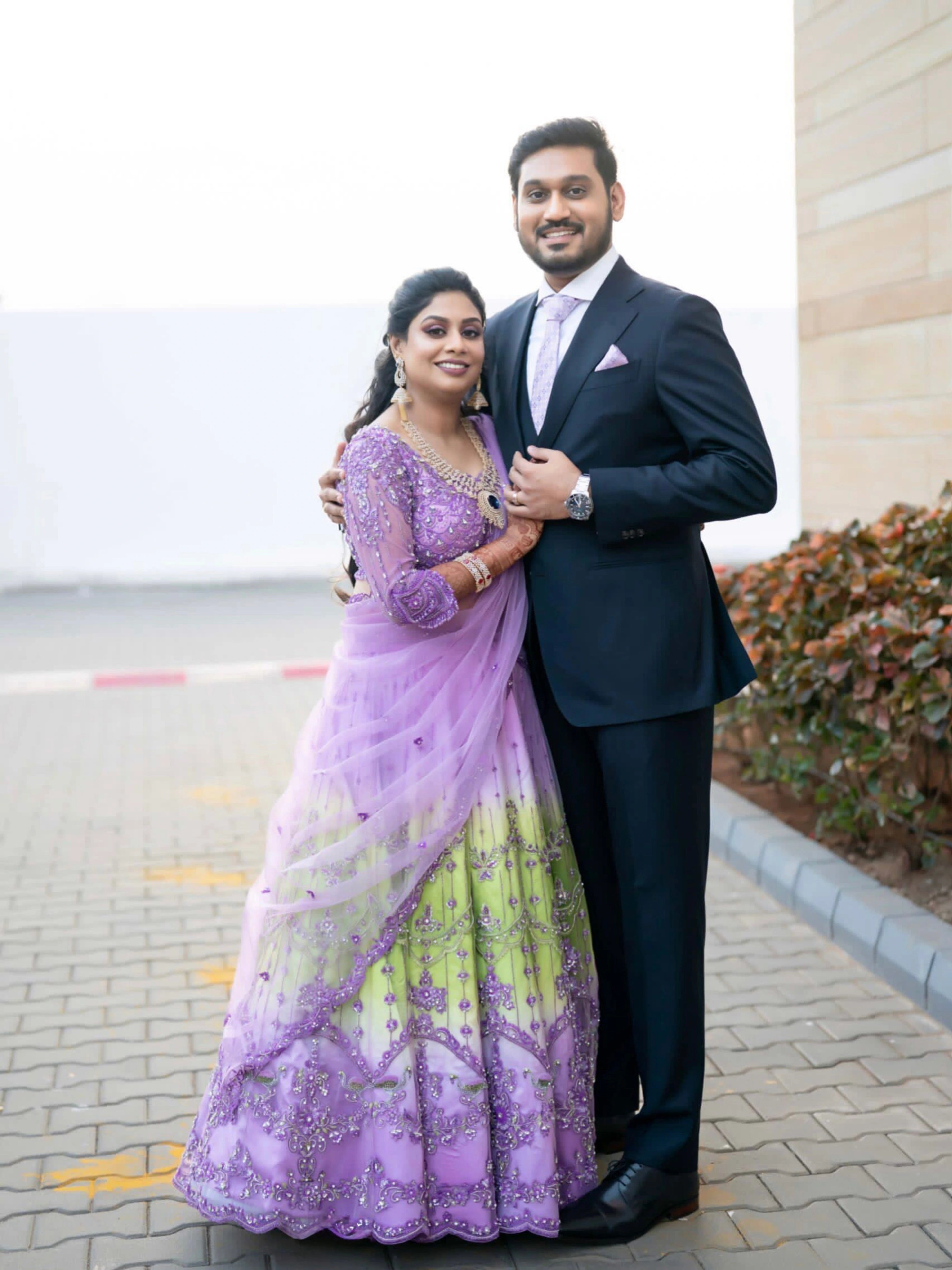 Bride Keerti posing in a lavender & green tulle lehenga, intricately handcrafted with sequins, cutdana, beads, crystals, rhinestones & zardozi by team Archana Karthick