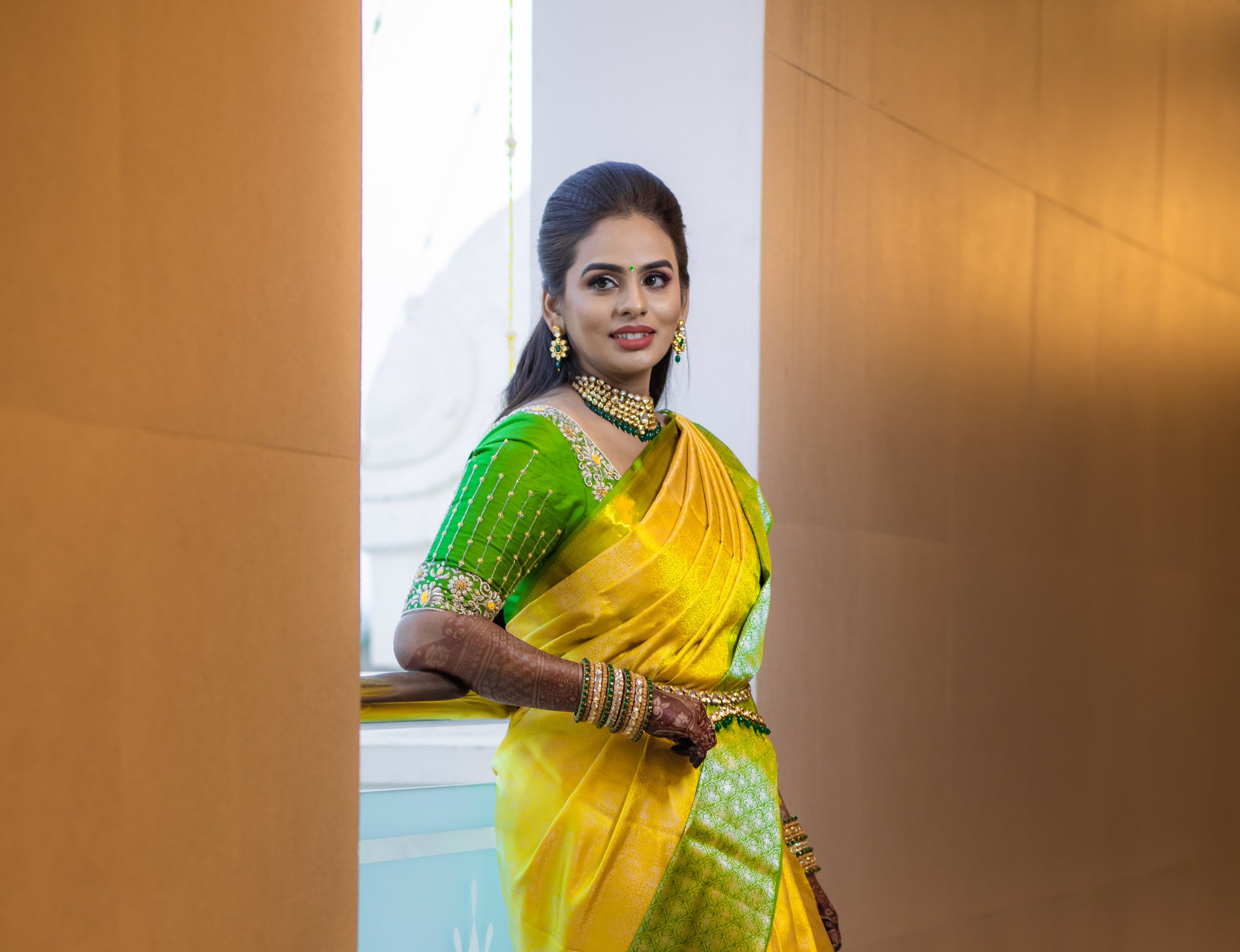 Bride Kowsalya in a handcrafted green silk blouse by Archana Karthick. Posing to her right again.