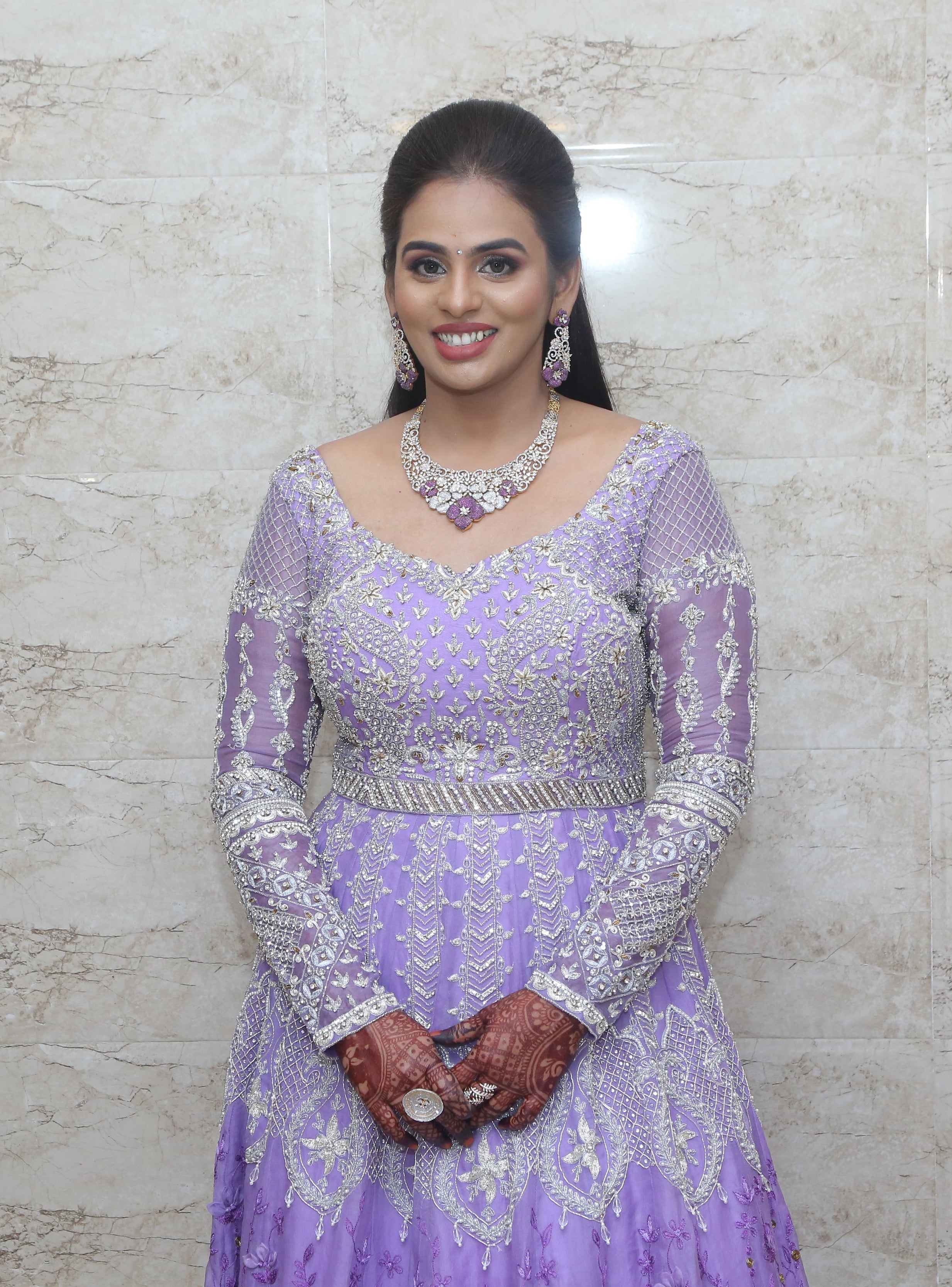 Bride Kowsalya in handcrafted lavender bridal gown designed by Archana Karthick. Full front profile.