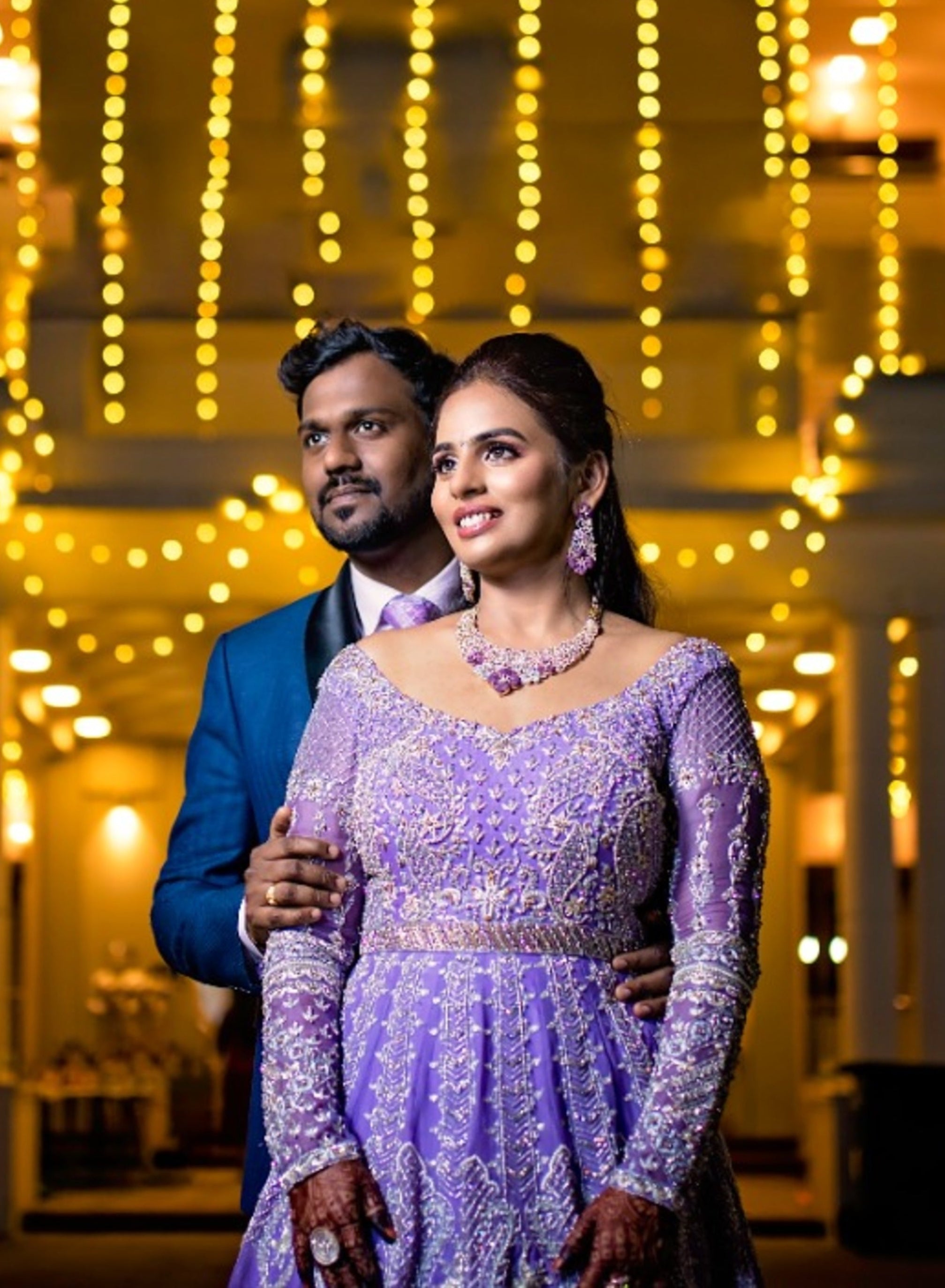 Bride Kowsalya in handcrafted lavender bridal gown designed by Archana Karthick. Full front profile with groom.