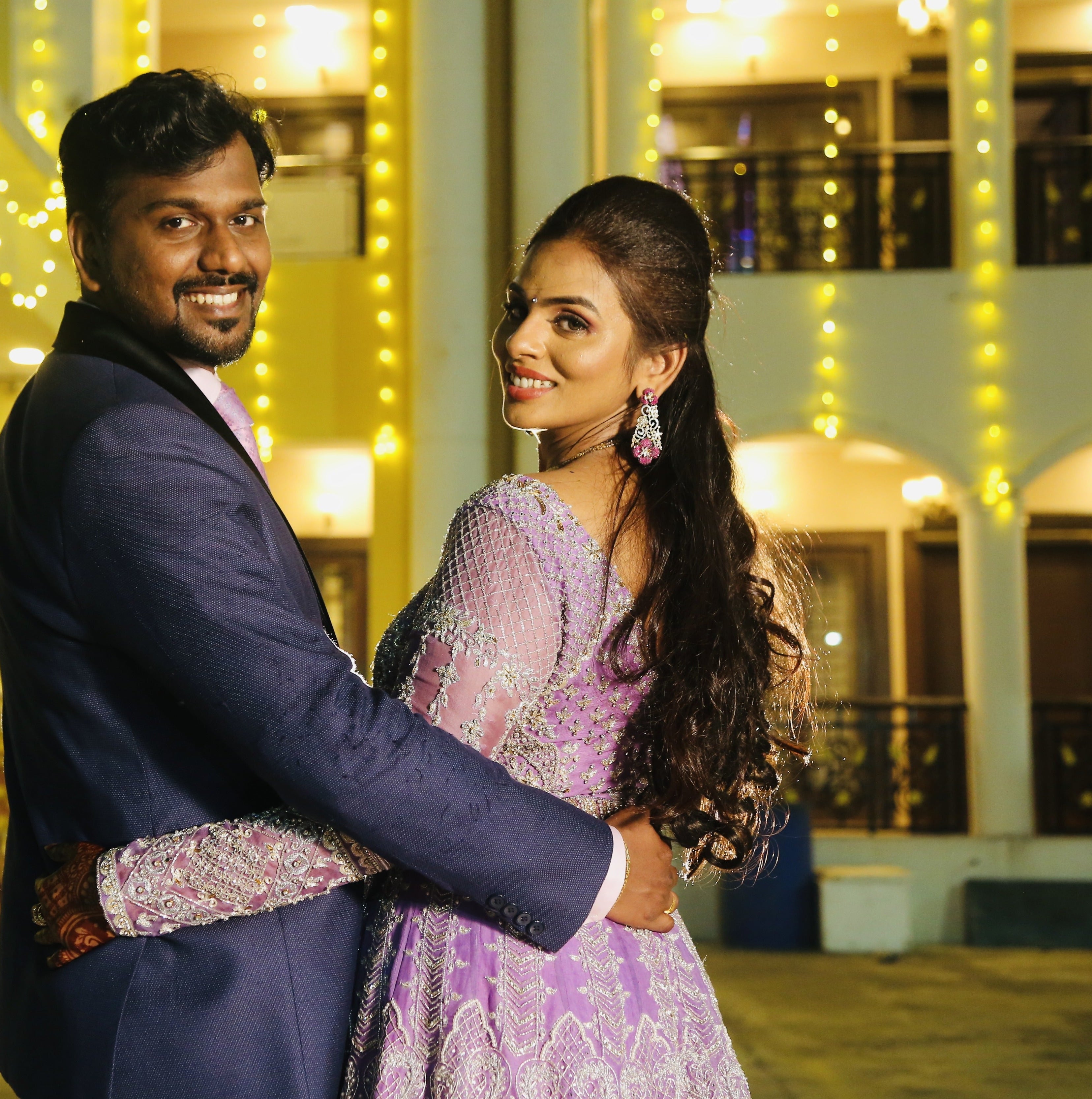 Bride Kowsalya in handcrafted lavender bridal gown designed by Archana Karthick. Posing with groom.