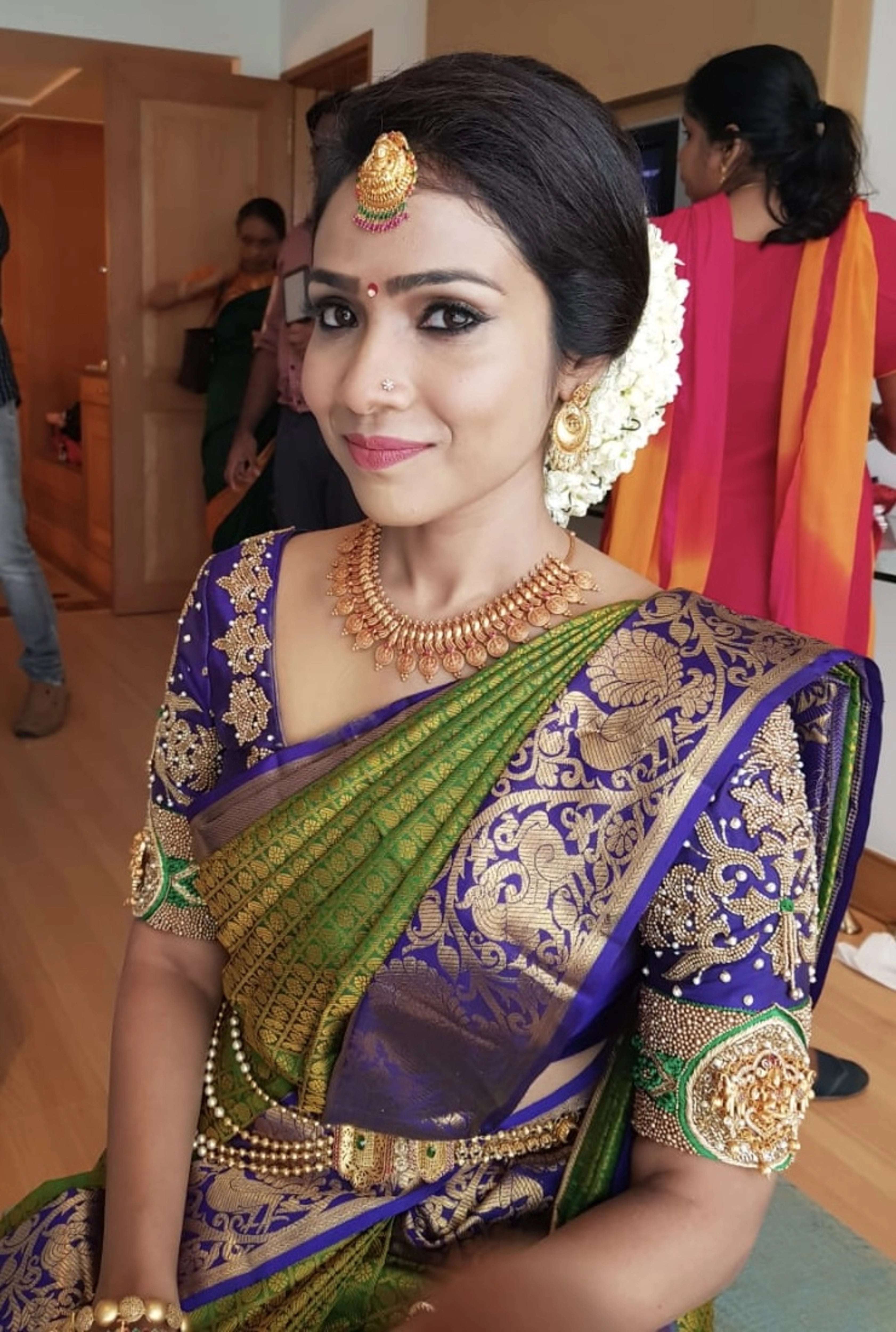 Bride Krishnapriya from Chennai in a blue silk blouse handcrafted intricately with beads, stones, resham and zardozi by team Archana Karthick.