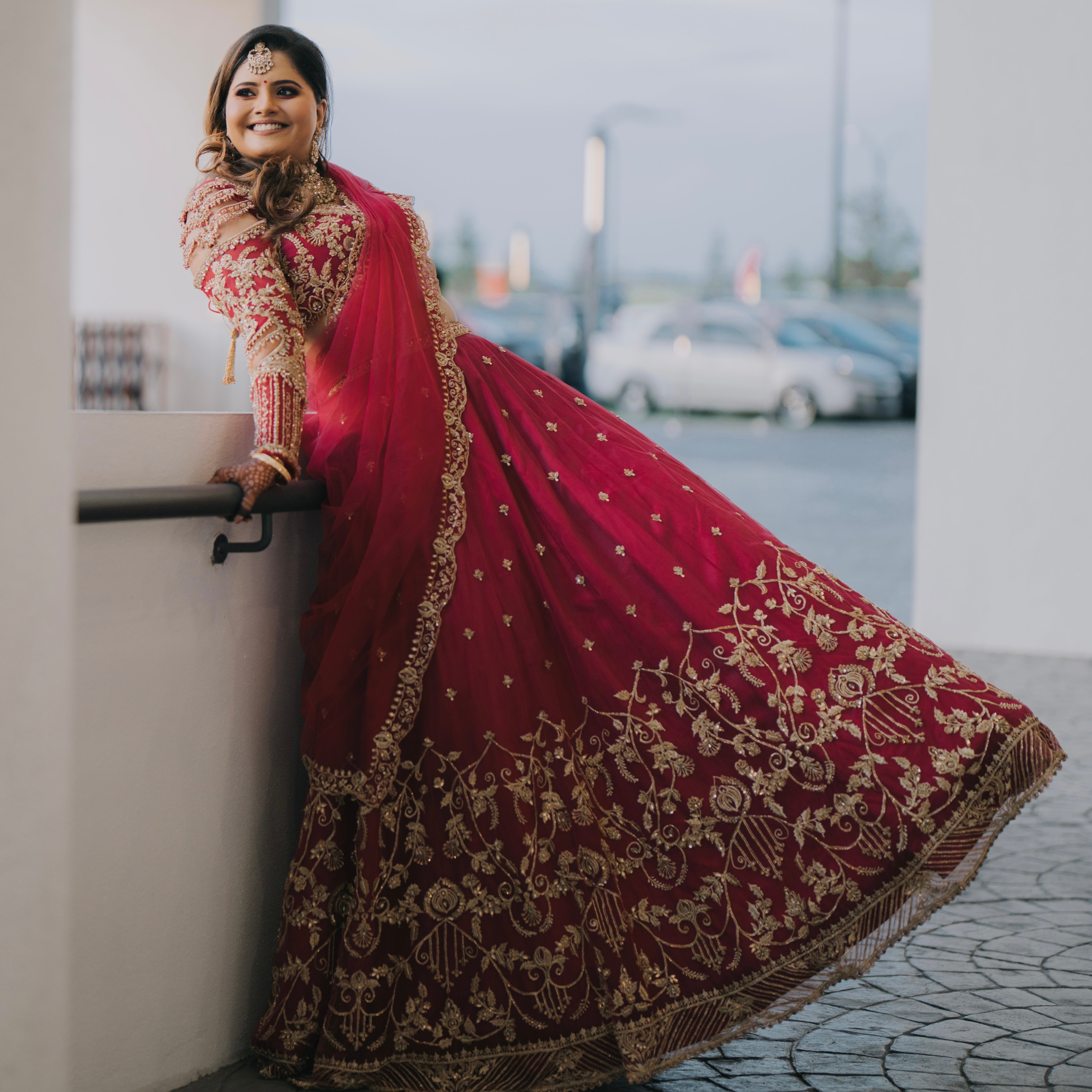 Bride Kritini Naidu from Malaysia posing for photoshoot in a pink lehenga by Archana 