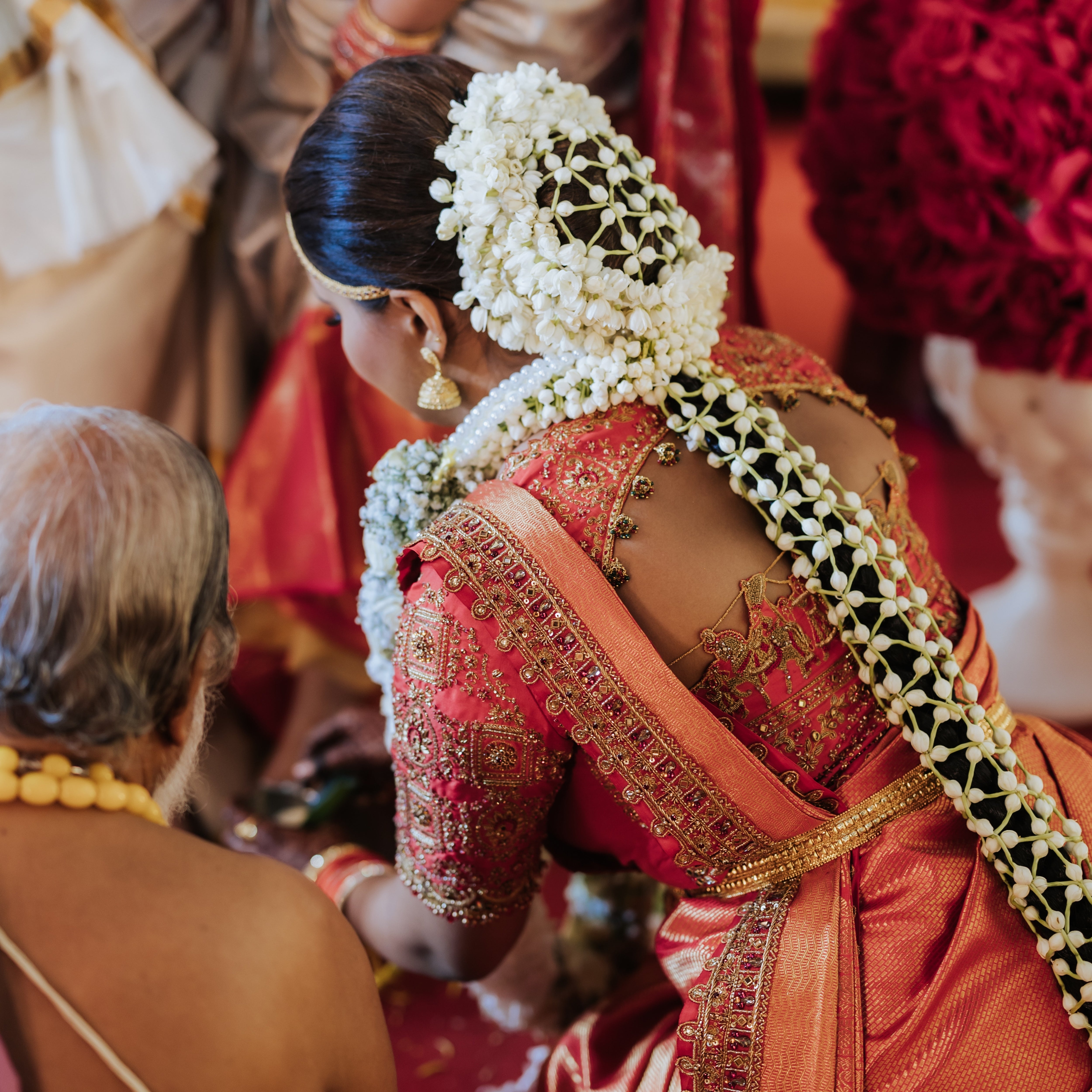 Bride Kritini Naidu from Malaysia posing in a red silk blouse & saree border by team Archana Karthick.