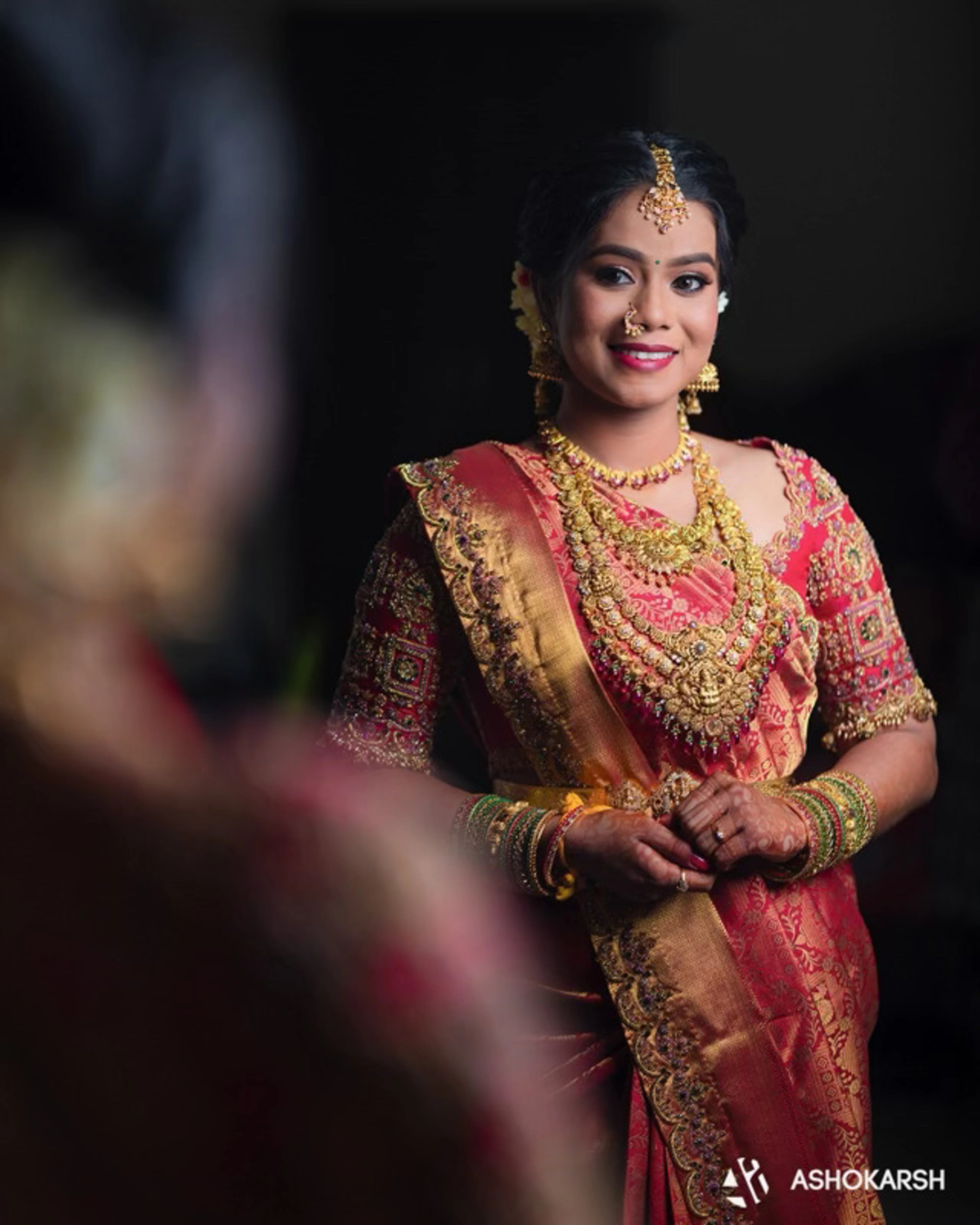 Bride Kushmma in a red silk blouse & saree border by Archana Karthick