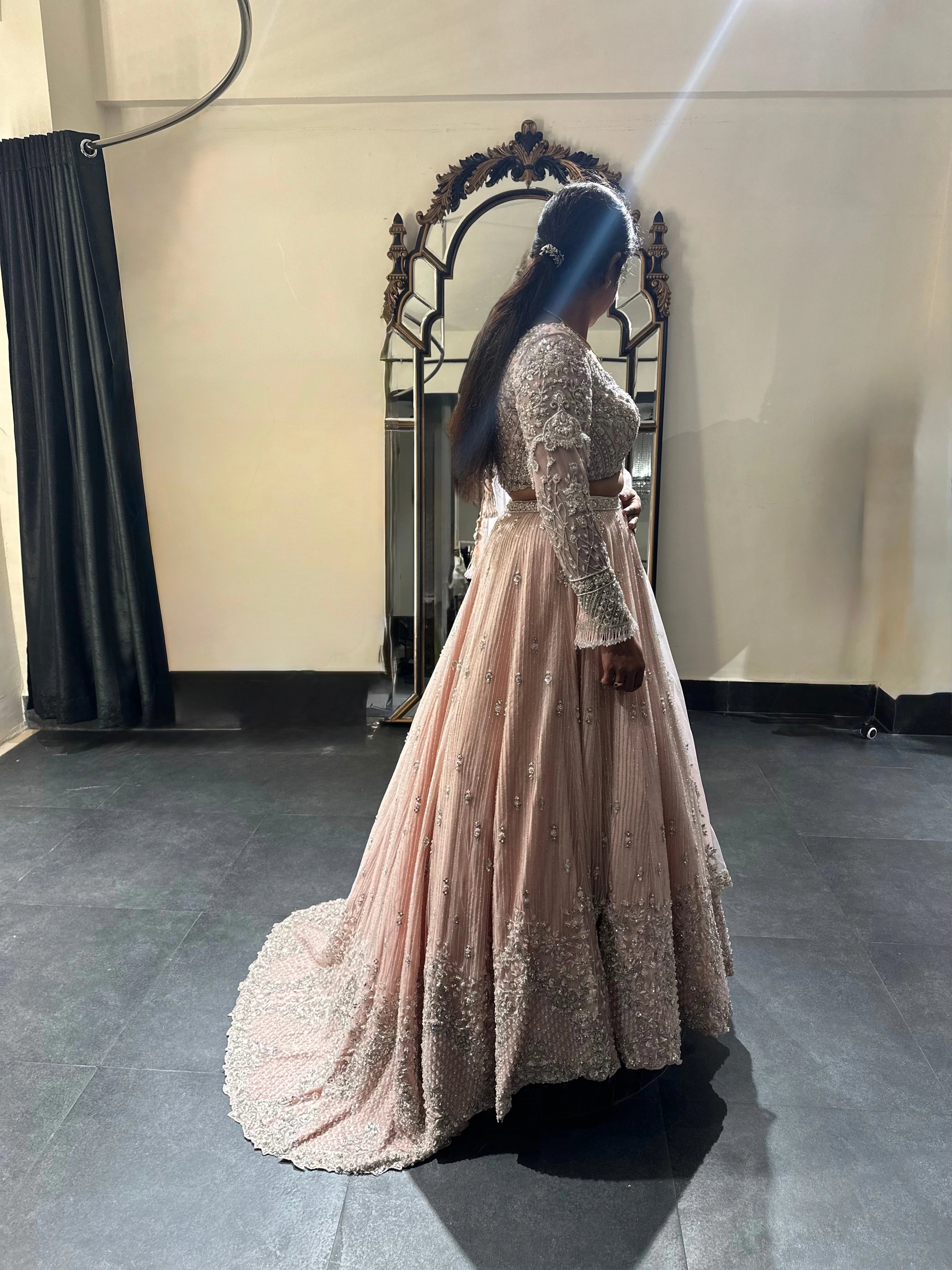 Bride Nandhini Krishnan in a blush tulle reception lehenga, handcrafted by team Archana Karthick.