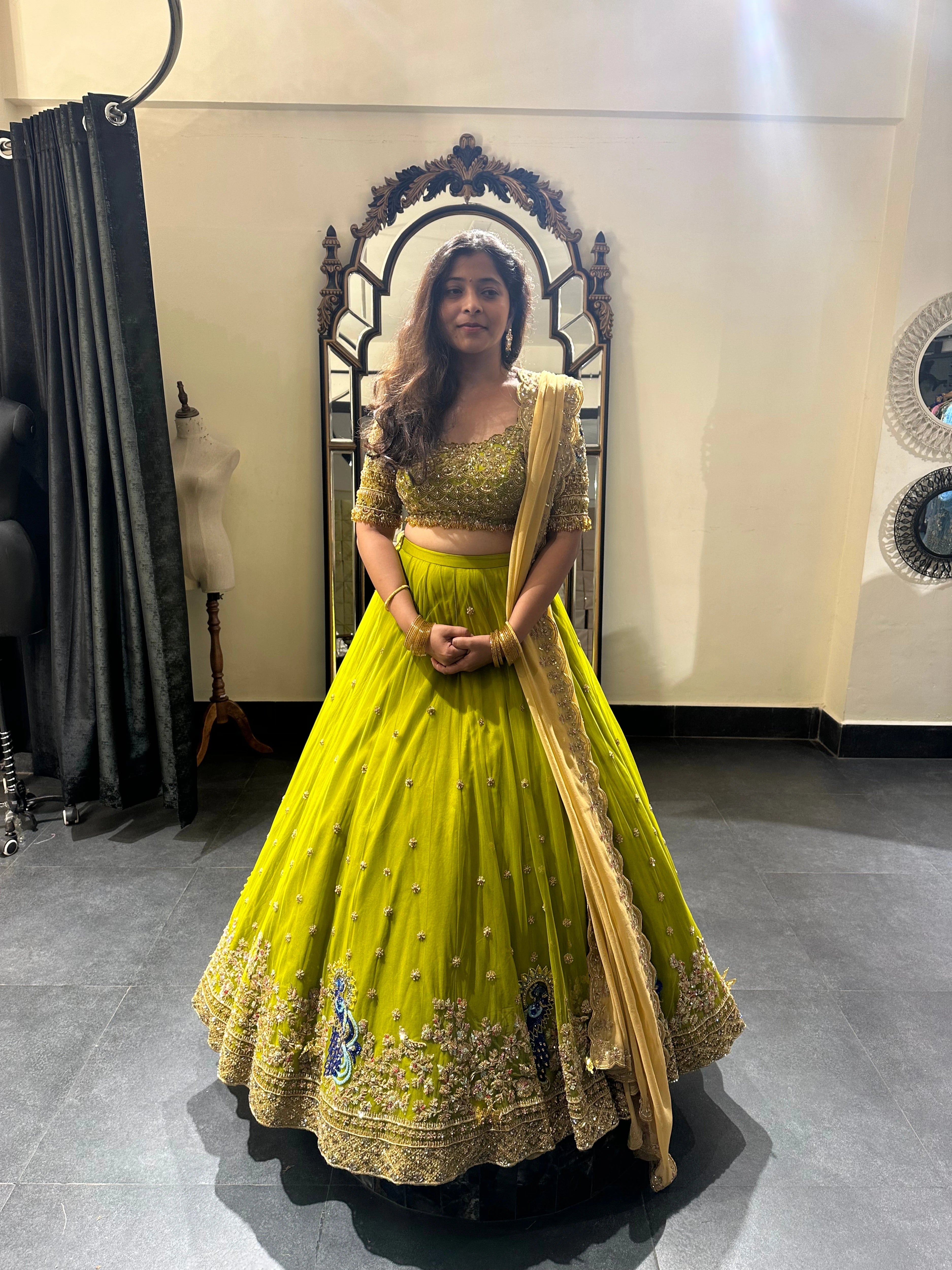Bride Nandita in a olive green tulle lehenga during fittings by team Archana Karthick.