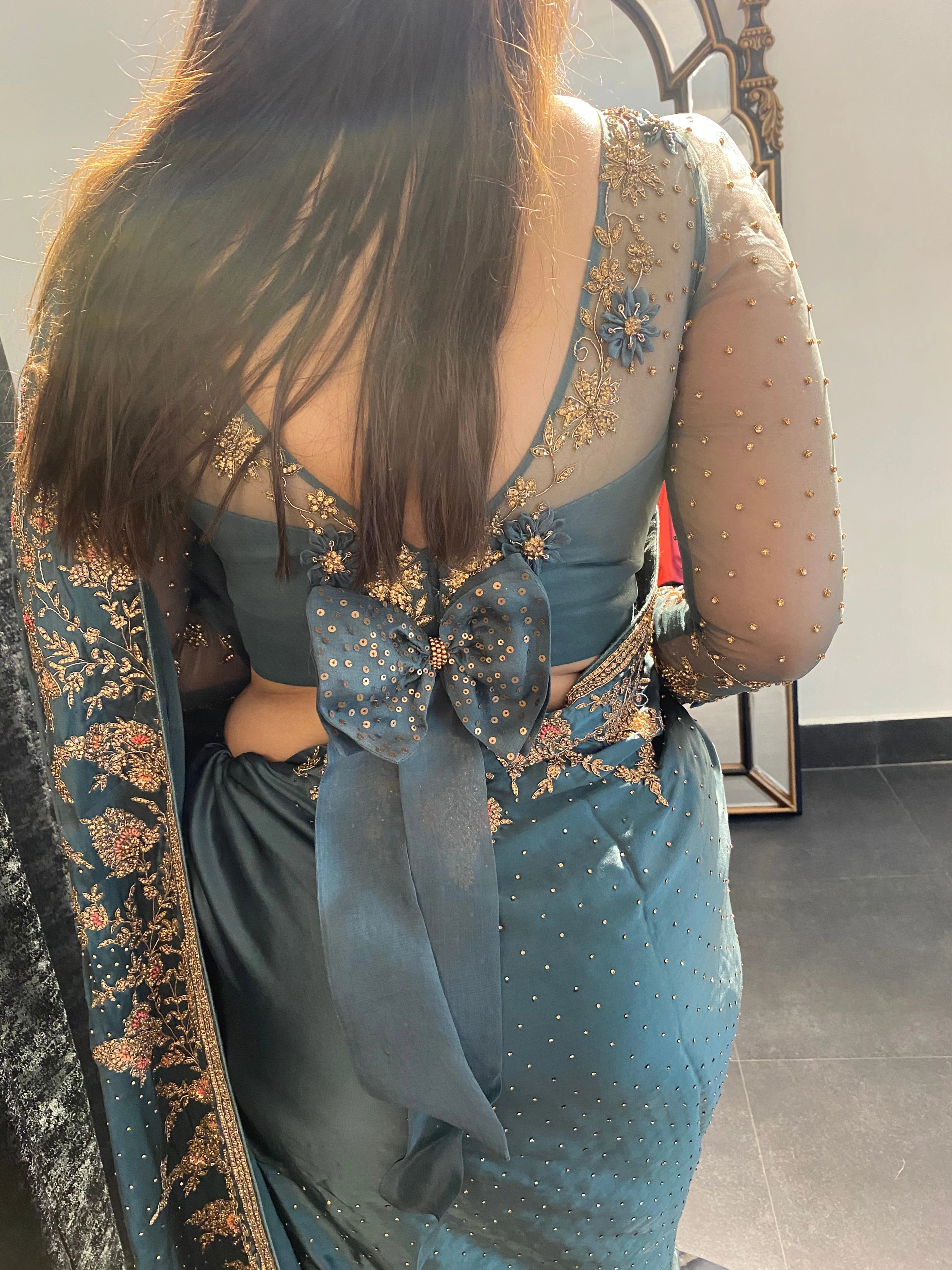 Bride Neha during fittings in a blue grey tulle blouse handcrafted by team Archana Karthick.