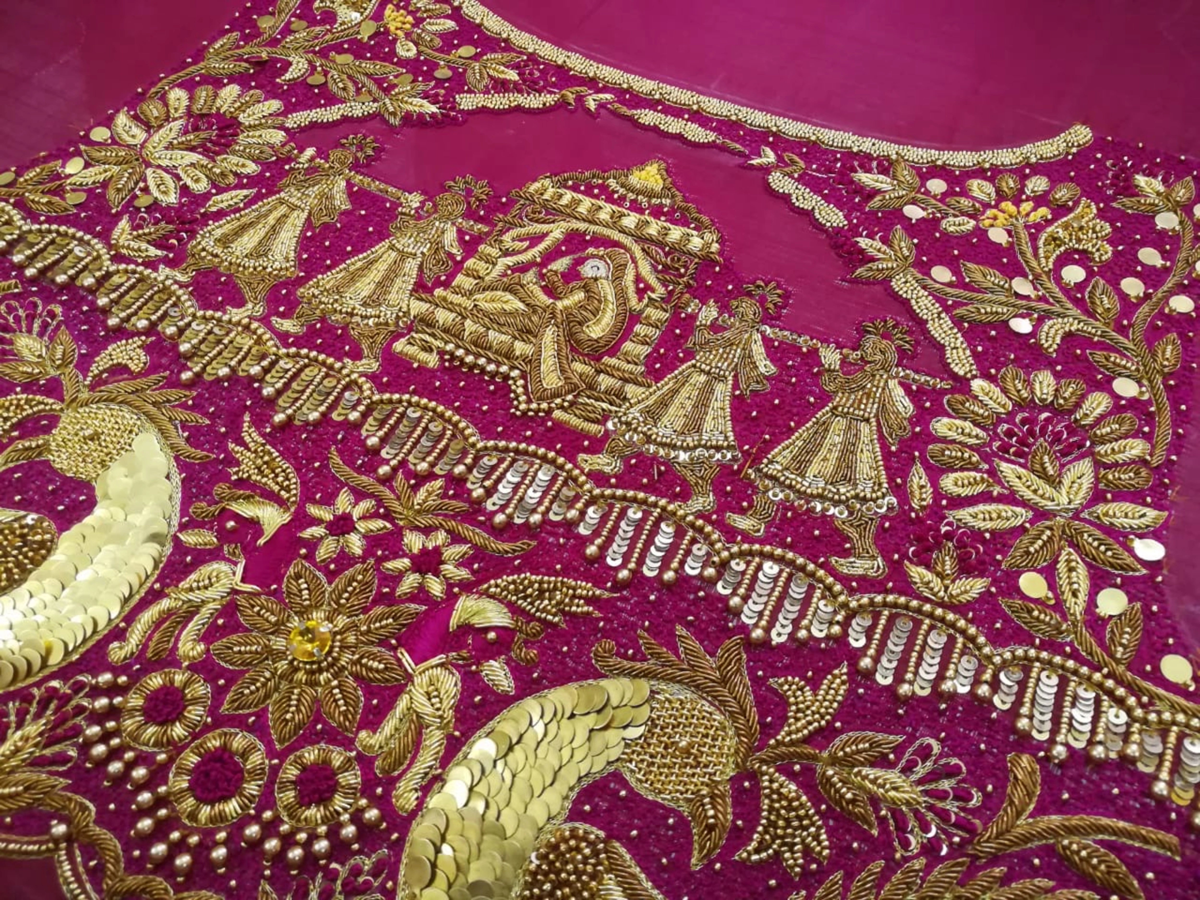 Bride Padma from Coimbatore showcasing back blouse design in a red silk palanquin concept blouse intricately handcrafted with zardozi, stones, beads, sequins etc by team Archana Karthick.