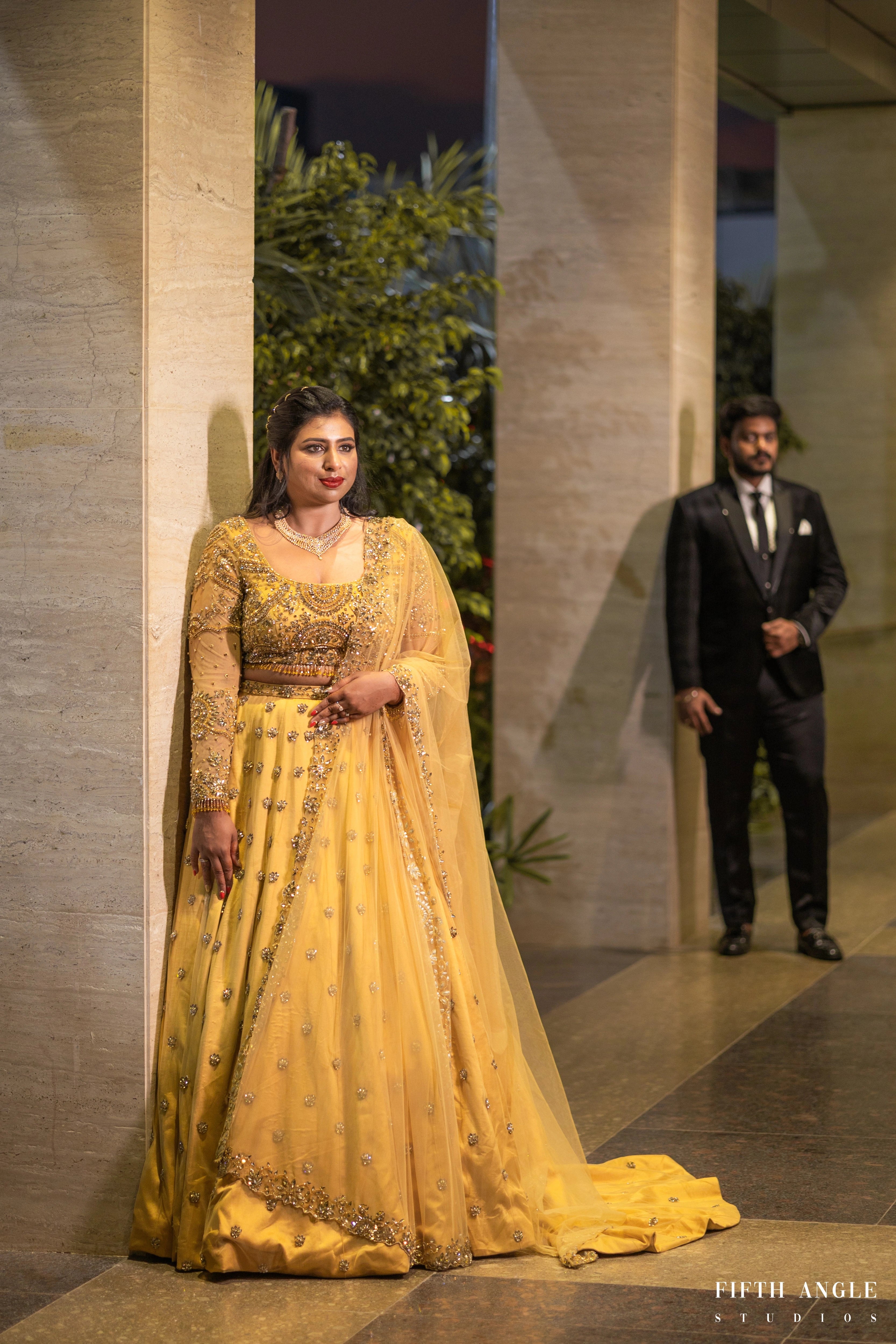 Bride Pooja Das in a golden tulle lehenga handcrafted by team Archana Karthick.