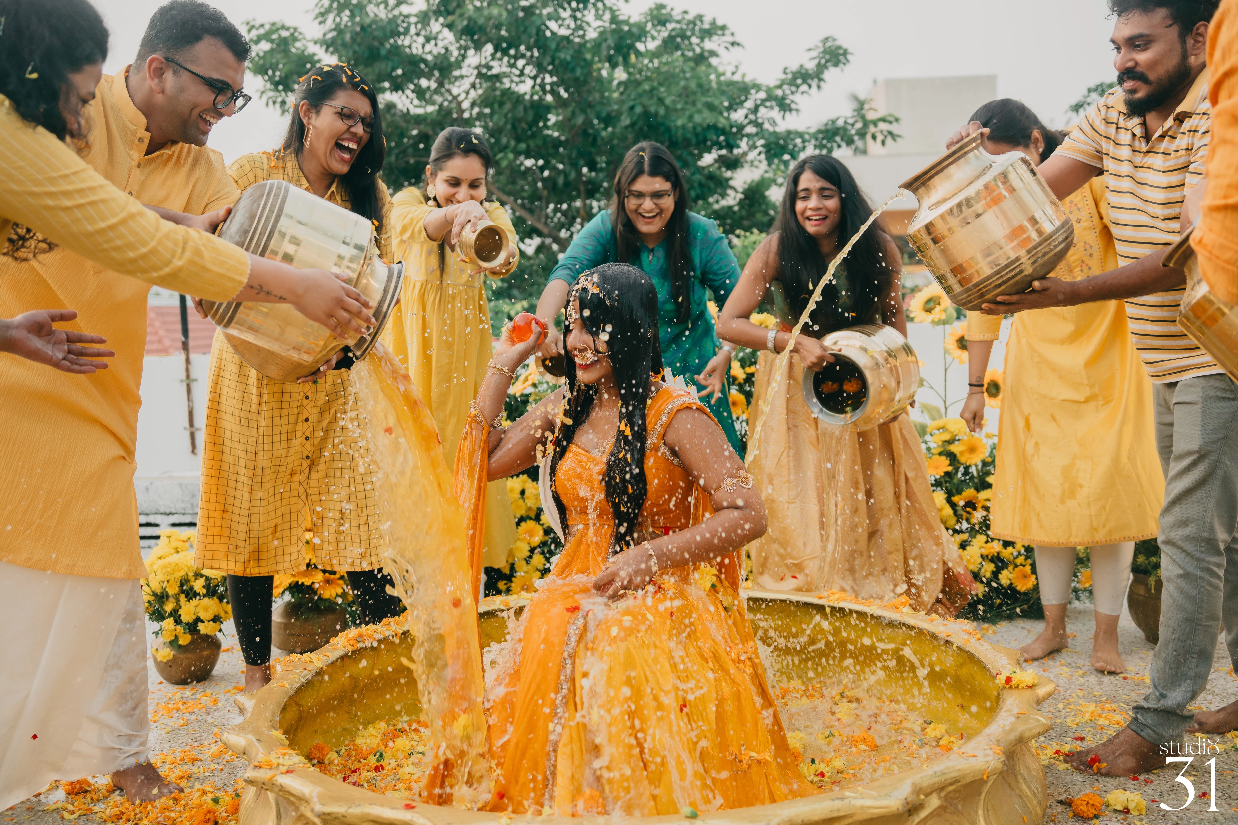 Bride Pooja for her haldi in a yellow silk half saree by team Archana Karthick.