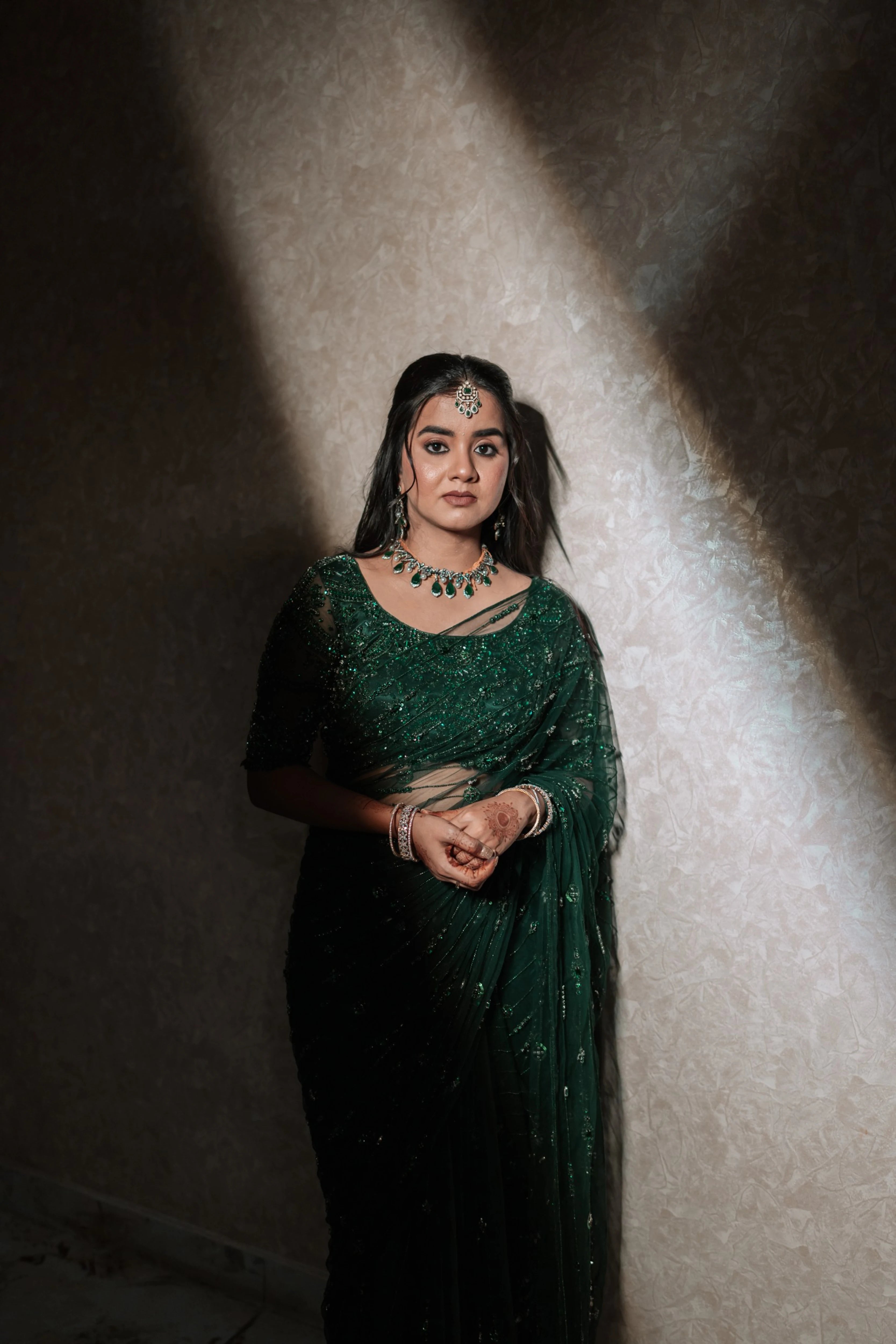 Bride Priyanka during photoshoot in a bottle green tulle saree, intricately handcrafted with rhinestones, zardozi, sequins, crystals, cutdana and stones by team Archana Karthick.
