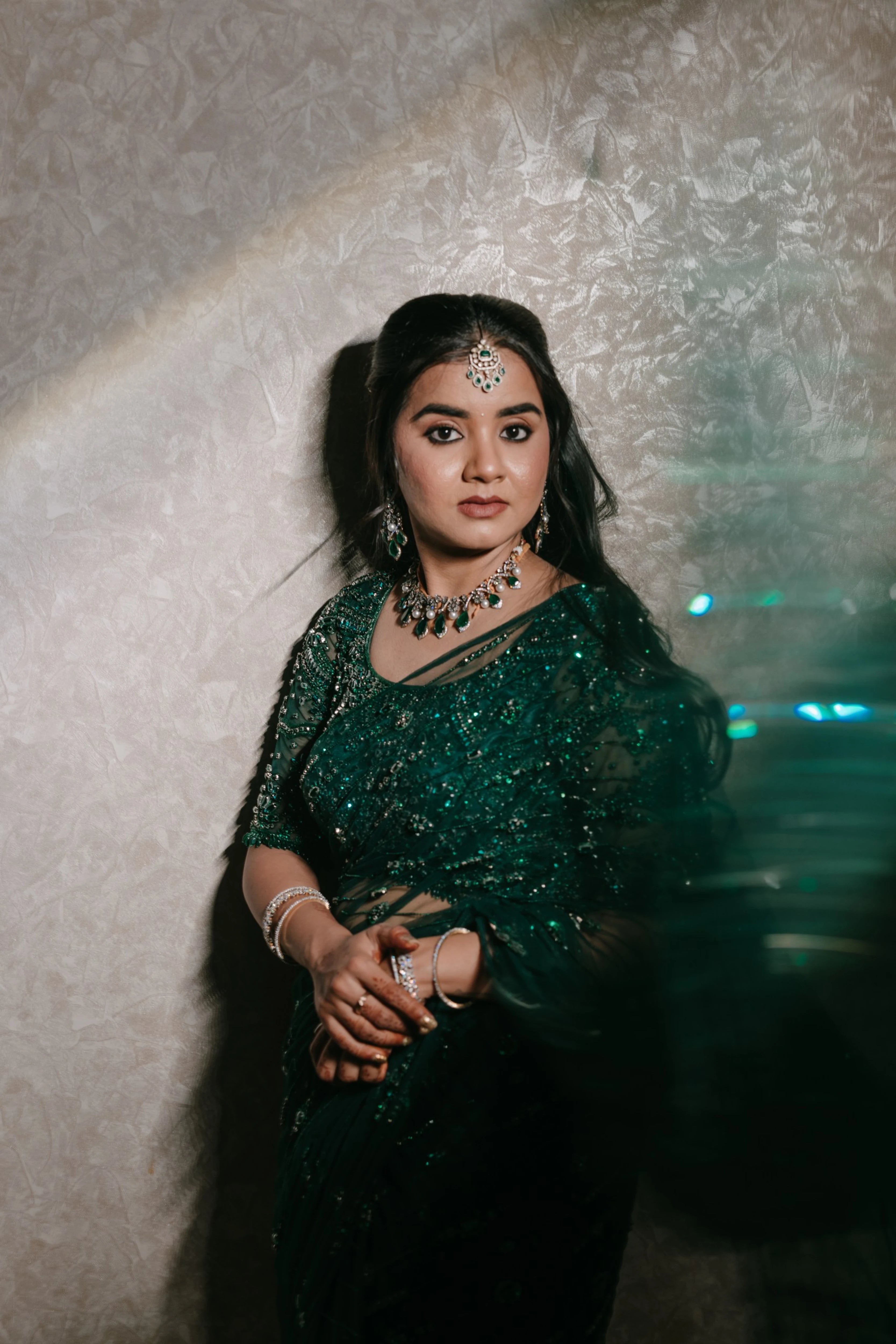 Bride Priyanka in a photoshoot in a bottle green tulle saree, intricately handcrafted with rhinestones, zardozi, sequins, crystals, cutdana and stones by team Archana Karthick.