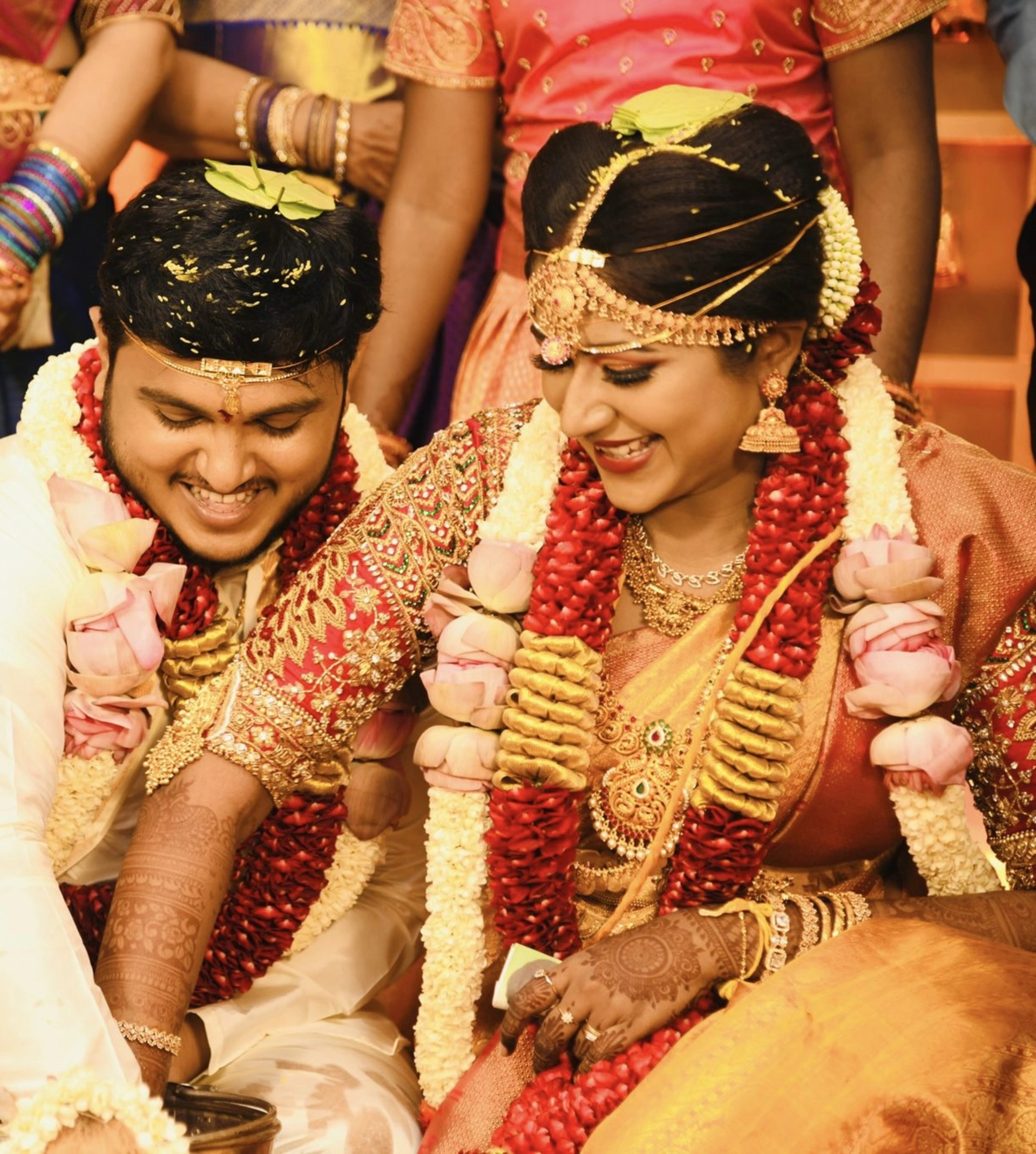 Bride Raji from Ireland in a red silk blouse, handcrafted with stones, zardozi, beads, sequins and kemp stones and goddess pendant by team Archana Karthick.