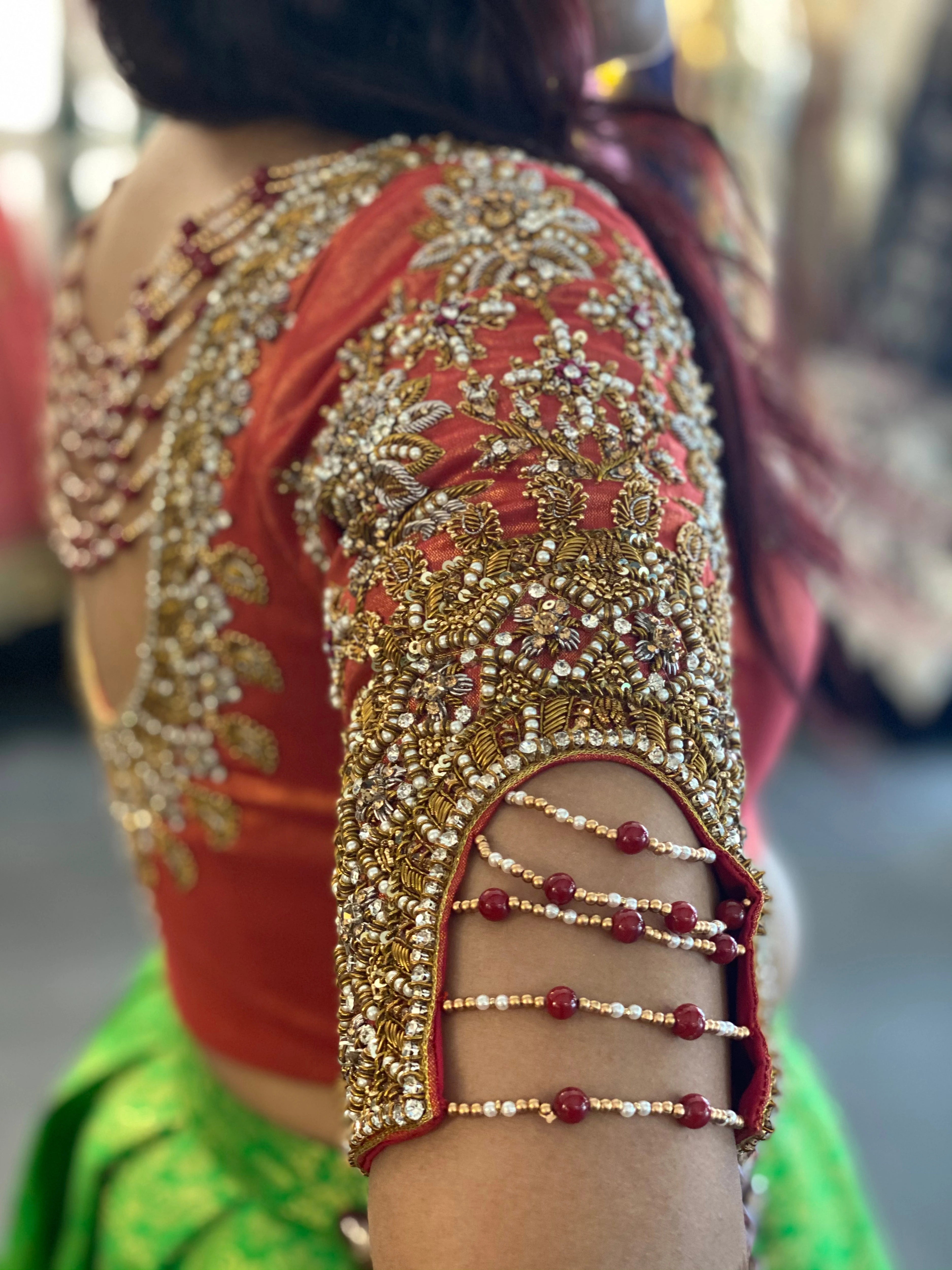 Bride Sai Sridevi in a burnt orange silk blouse handcrafted by team Archana Karthick.