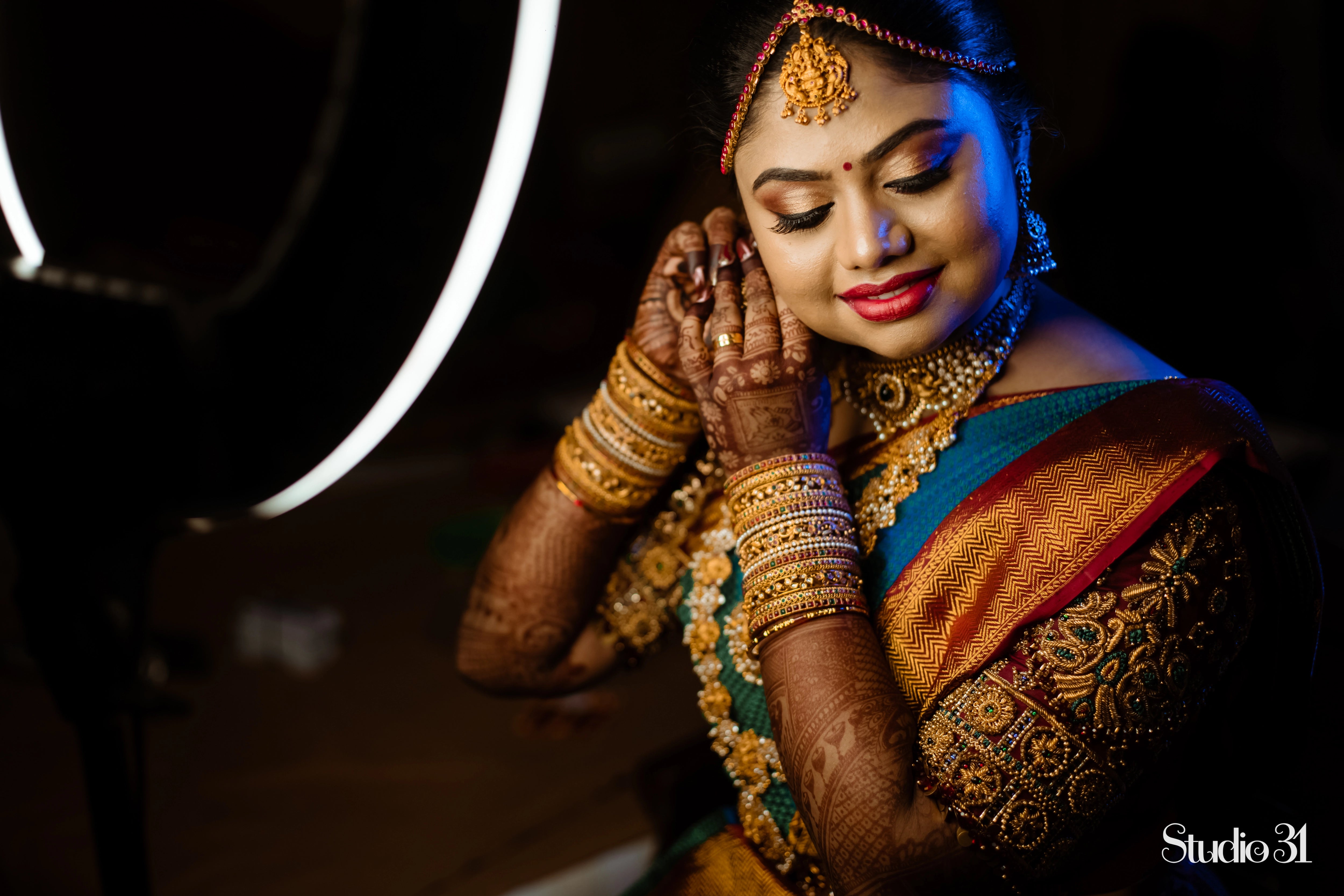 Bride Sailaja from USA in a maroon silk blouse, intricately handcrafted with beads, cutdana, kemp stones, resham and zardozi by team Archana Karthick.