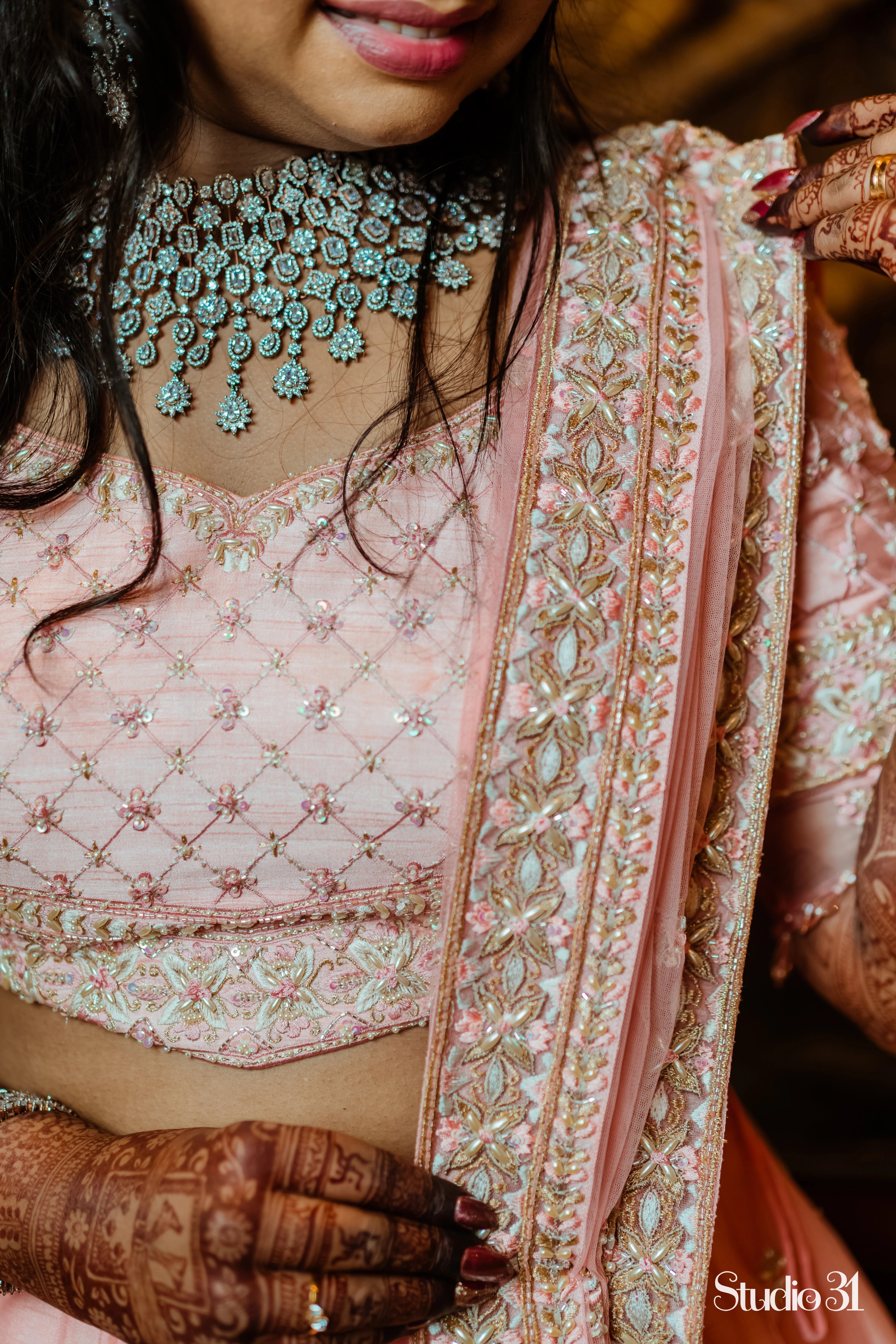 Bride Sailaja from USA showcasing detailings in a peach cream raw silk lehenga, intricately handcrafted with pearls, sequins, cutdana, beads, zari and resham by team Archana Karthick.
