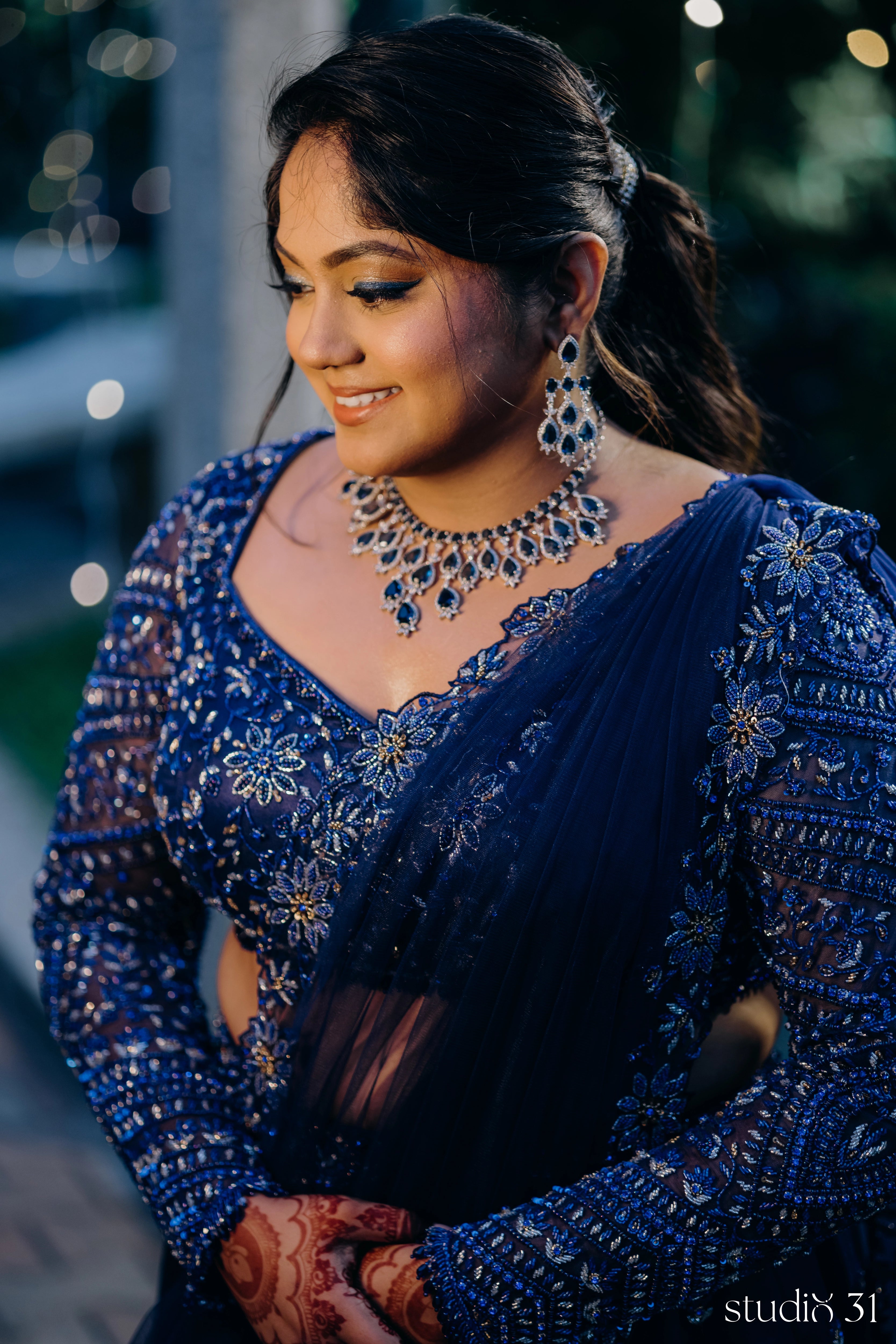 Bride Sambavi from Singapore in a midnight blue lehenga by Archana Karthick