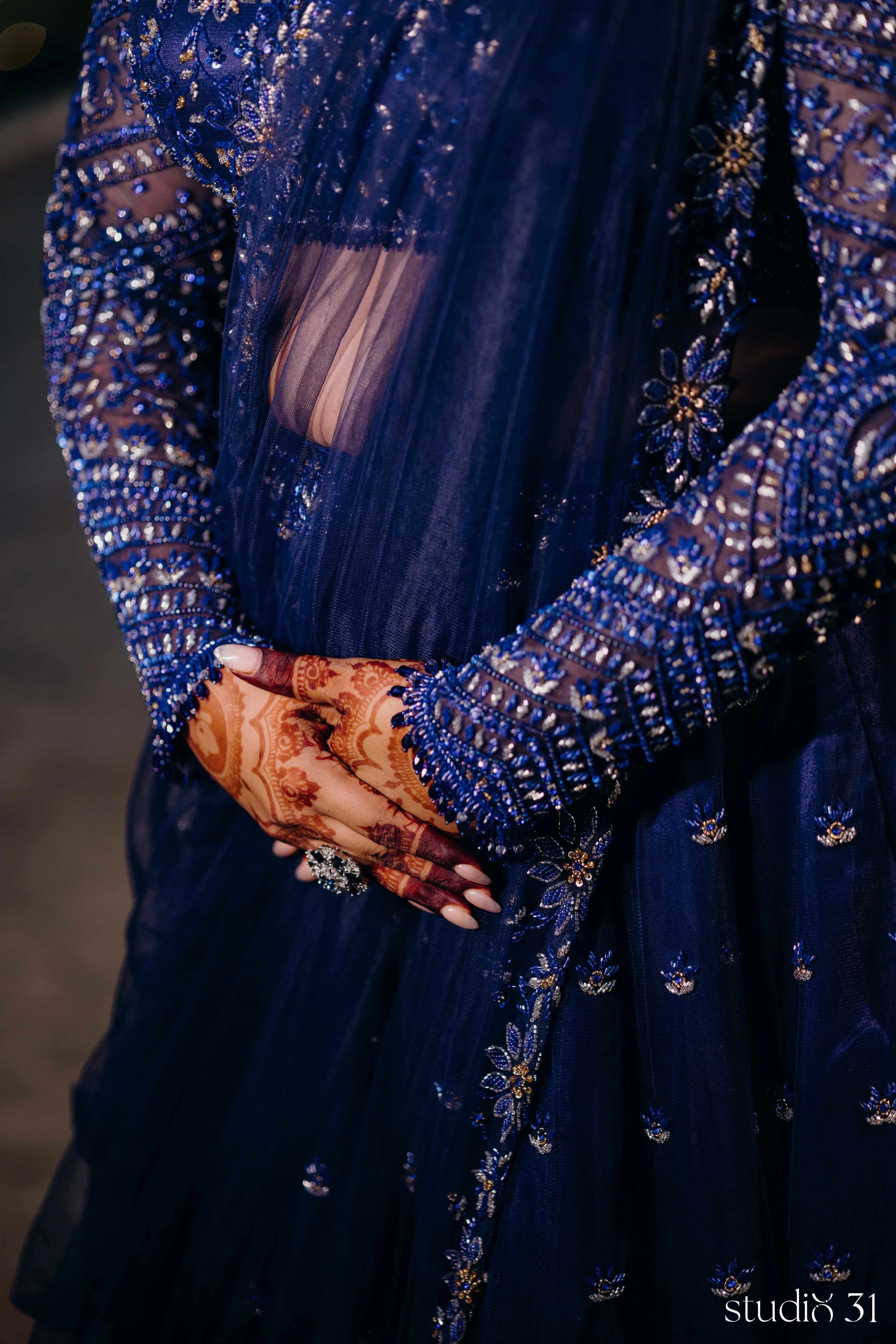 Bride Sambavi from Singapore posing in a midnight blue lehenga by Archana Karthick