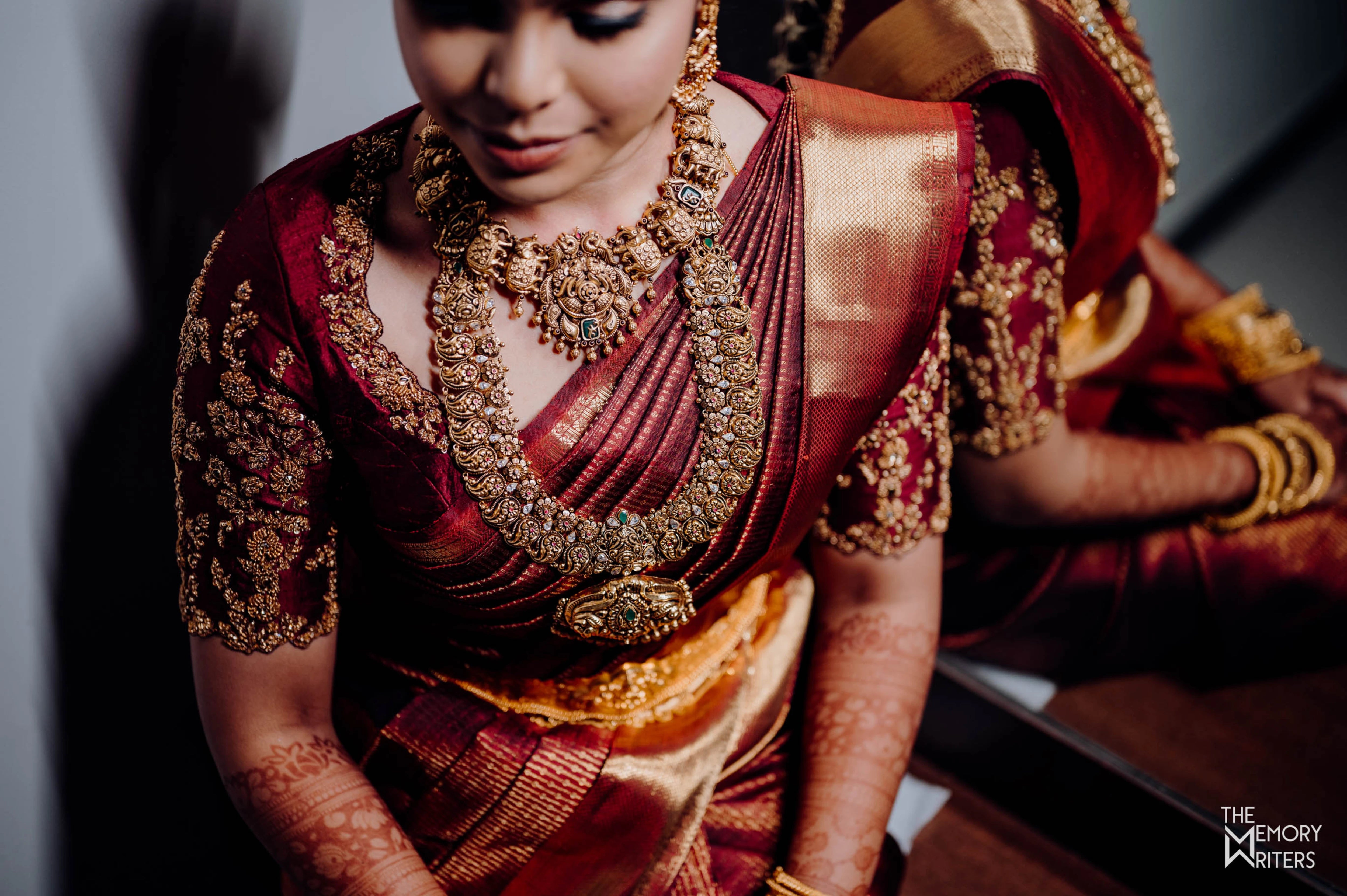 Bride Sangamithra from Coimbatore in a maroon rawsilk blouse, intricately handcrafted with sequins, zardozi, kundan and stones by team Archana Karthick.