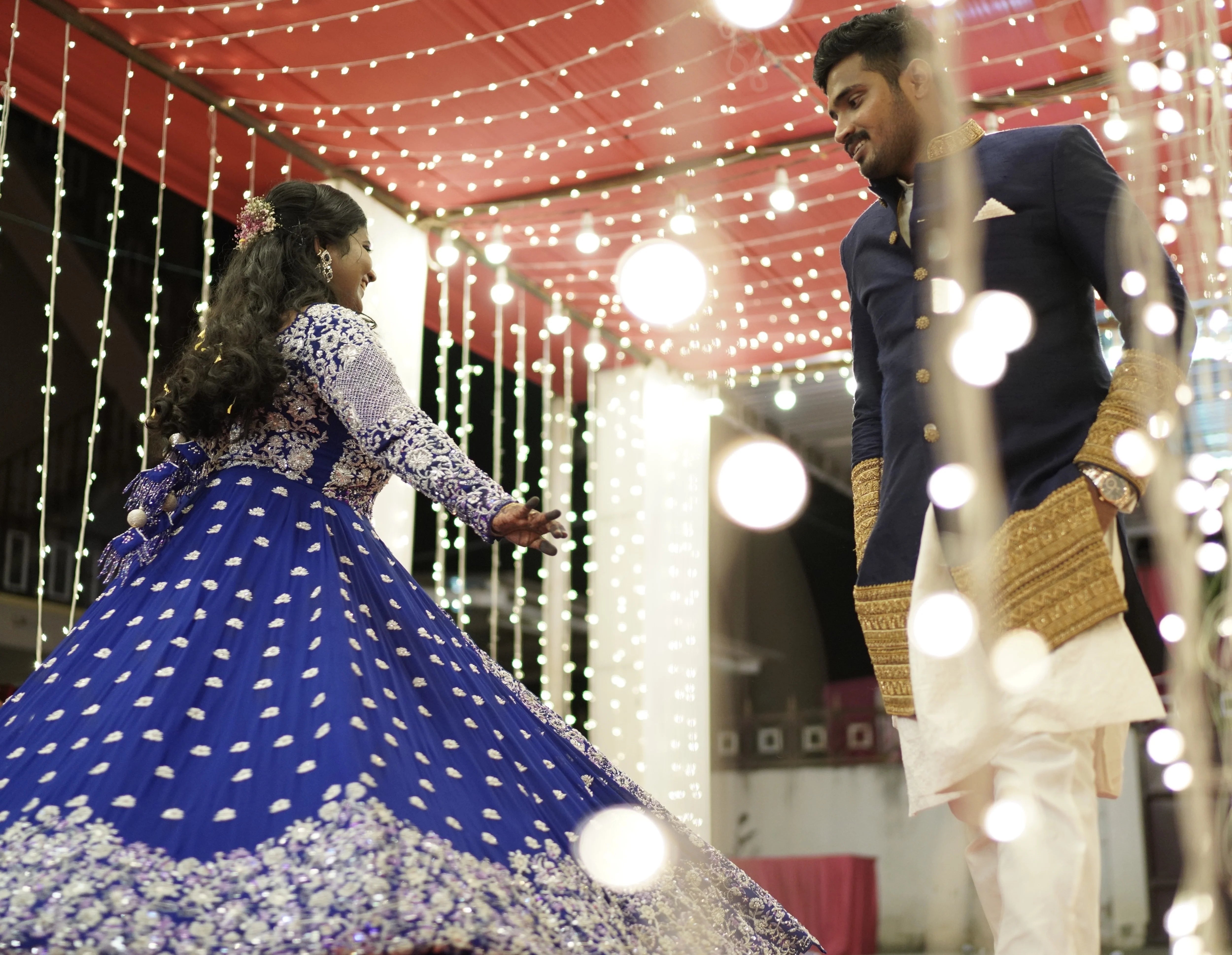 Bride Sathiyapriya twirling in a midnight blue georgette masakali lehenga for her reception in Dindigul while groom looks