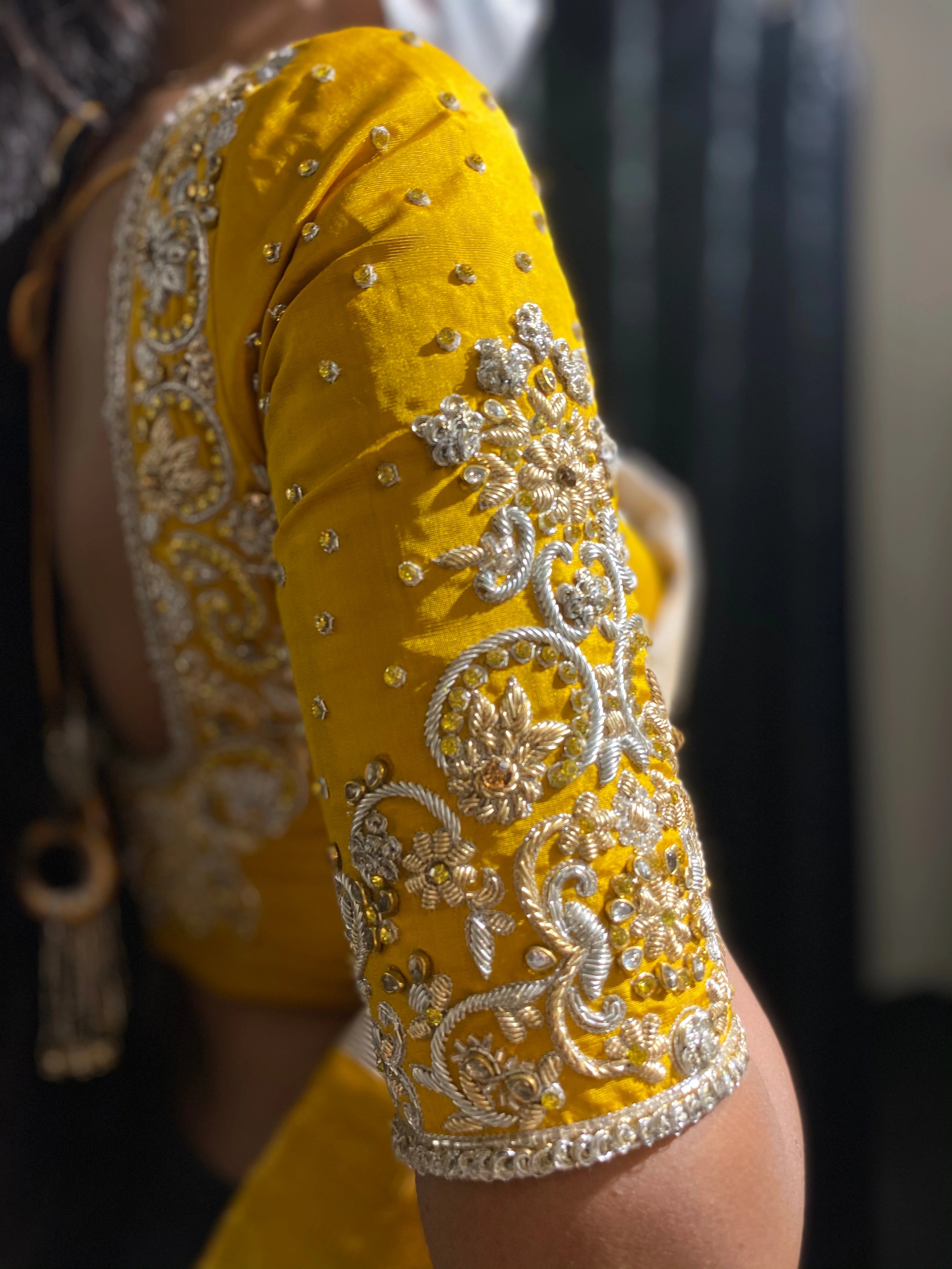 Bride Shanmugapriya in a yellow silk blouse by team Archana Karthick.