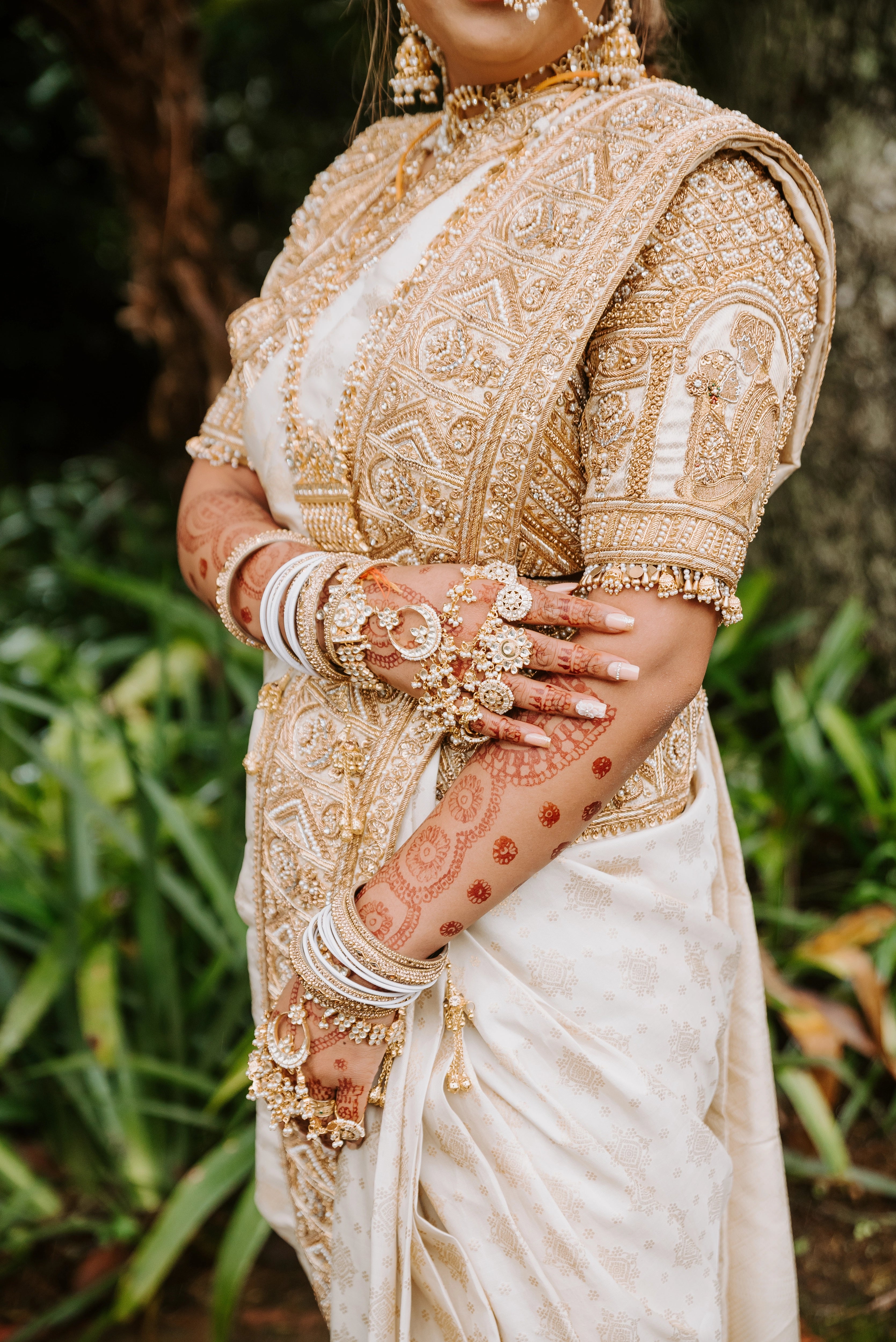 Bride Shayal Raniga in an ivory silk concept blouse & saree border, intricately handcrafted with zardozi, stones, pearls and coins by team Archana Karthick.