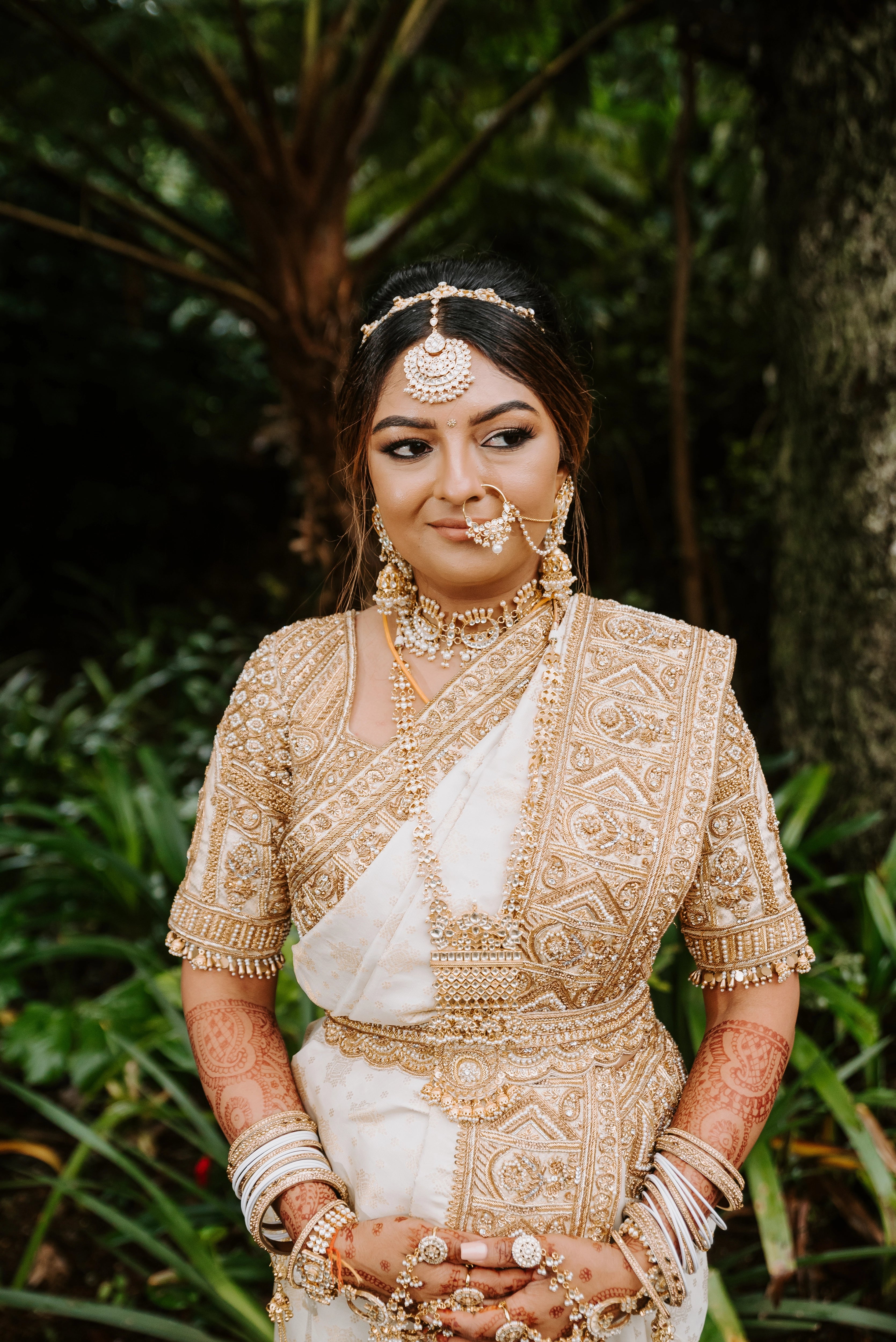 Bride Shayal Raniga smiling in an ivory silk concept blouse & saree border, intricately handcrafted with zardozi, stones, pearls and coins by team Archana Karthick.