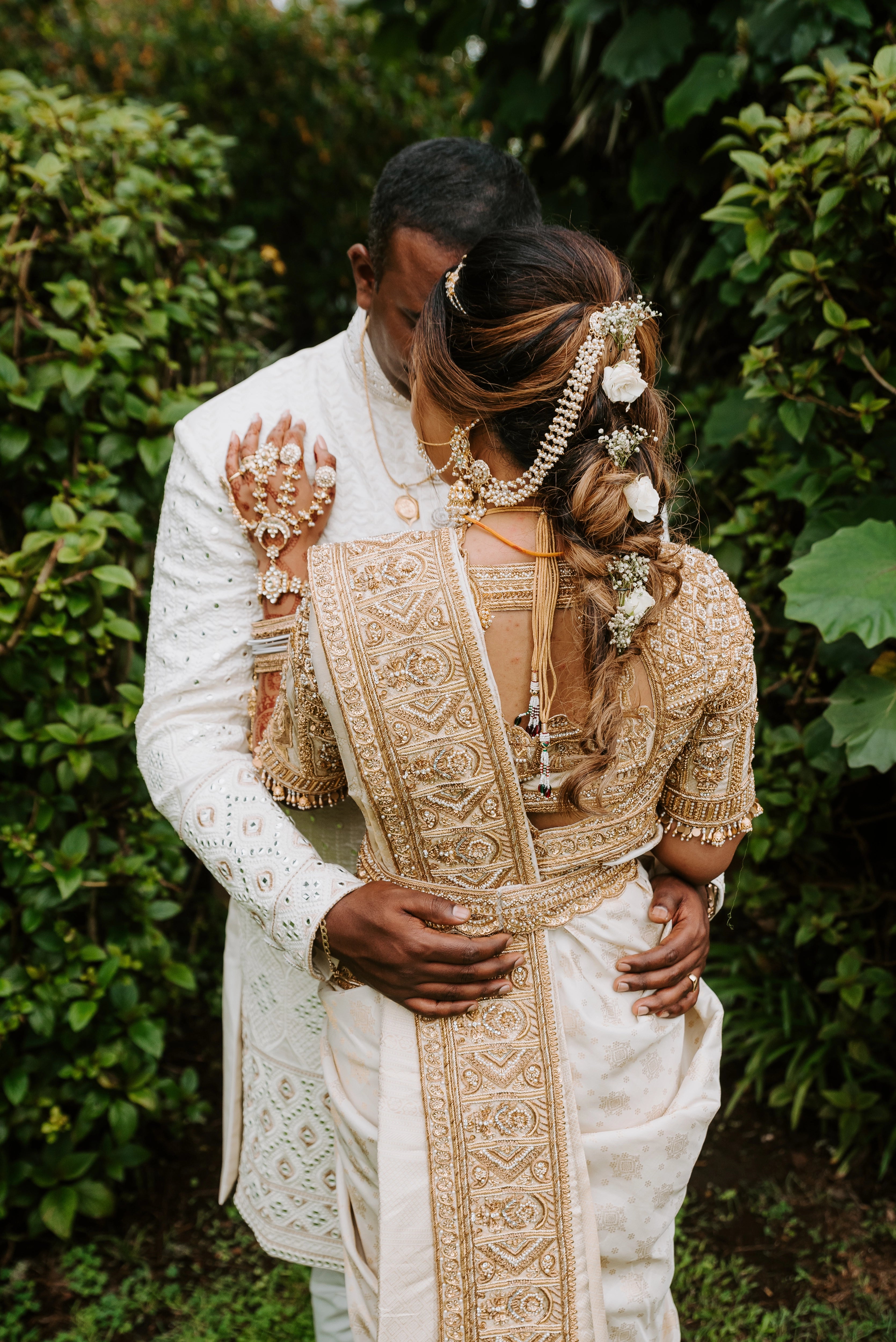 Bride Shayal Raniga with groom in an ivory silk concept blouse & saree border, intricately handcrafted with zardozi, stones, pearls and coins by team Archana Karthick.