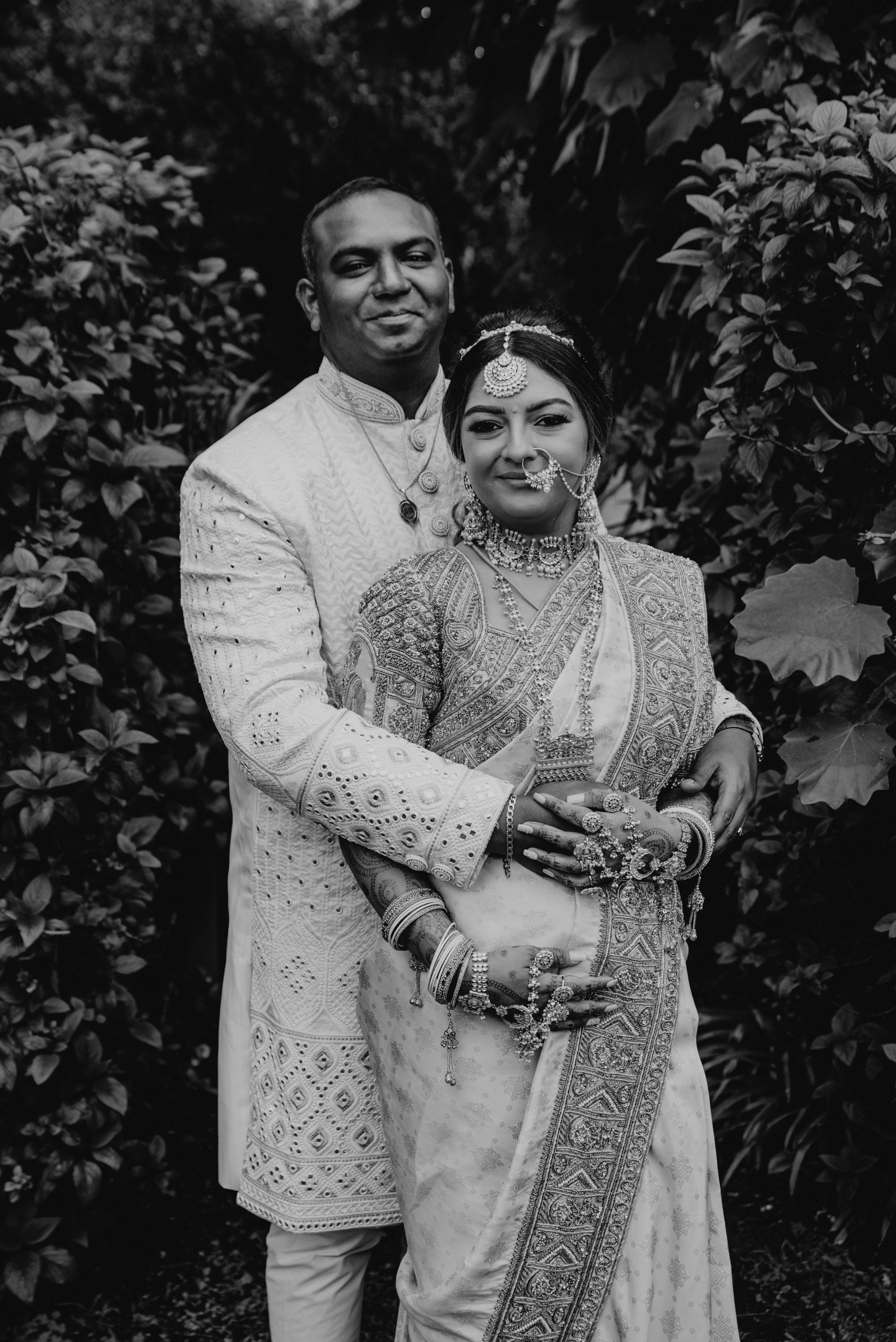 Bride Shayal in a black and white photo with groom in an ivory silk concept blouse & saree border, intricately handcrafted with zardozi, stones, pearls and coins by team Archana Karthick.