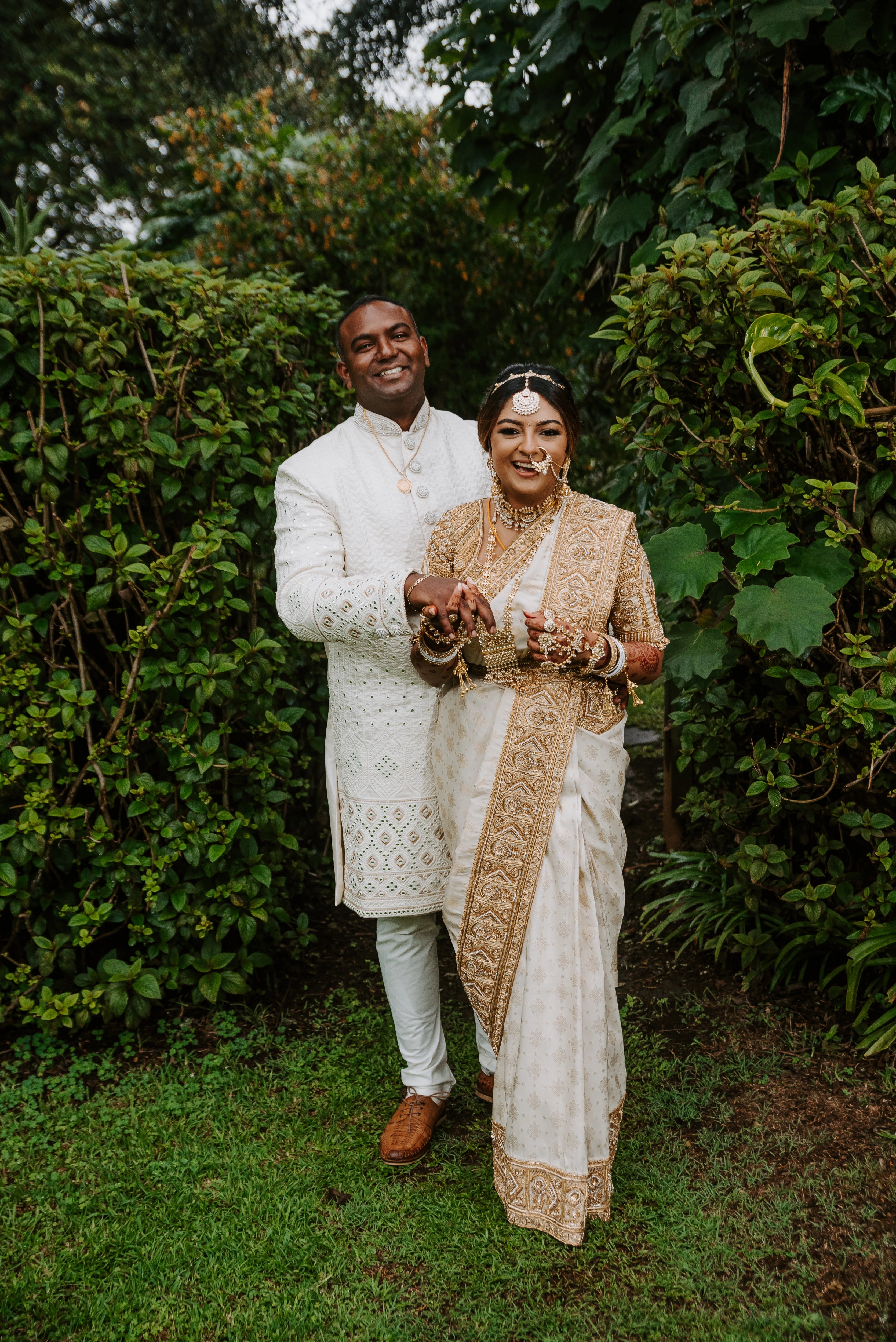 Bride Shayal laughing with groom in an ivory silk concept blouse & saree border, intricately handcrafted with zardozi, stones, pearls and coins by team Archana Karthick.